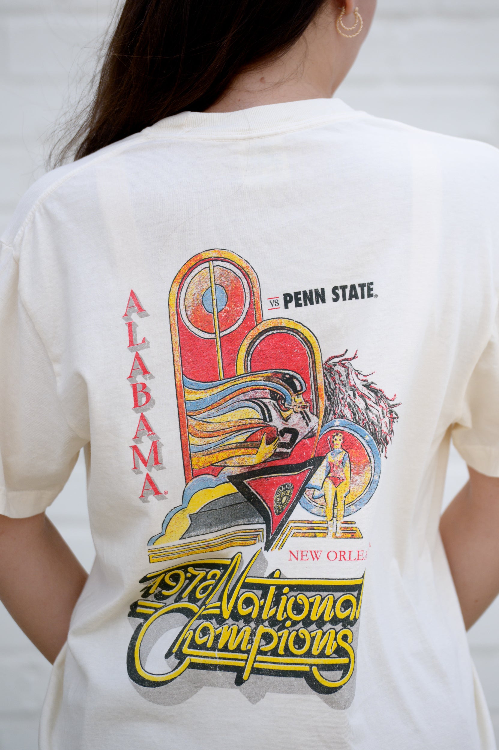 University of Alabama 1978 National Champions Comfort Colors Ivory T- Shirt with an image of a football player running with a football and a color guard woman and yellow retro neon sign style text "1978 National Champions"