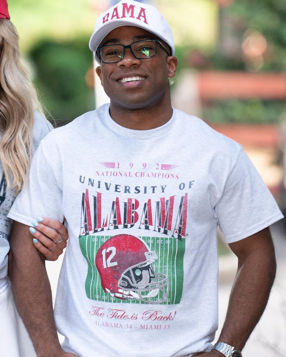 University of Alabama 1992 National Champions Comfort Colors Grey T-Shirt with a graphic print of a football helmet and the text '1992 National Champions UNIVERSITY OF ALABAMA'.