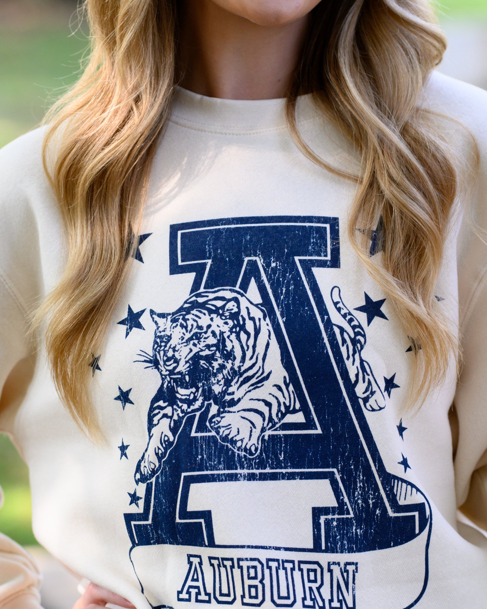 Auburn University Ivory Sweatshirt with Navy stars surrounding a Navy Leaping Tiger Logo