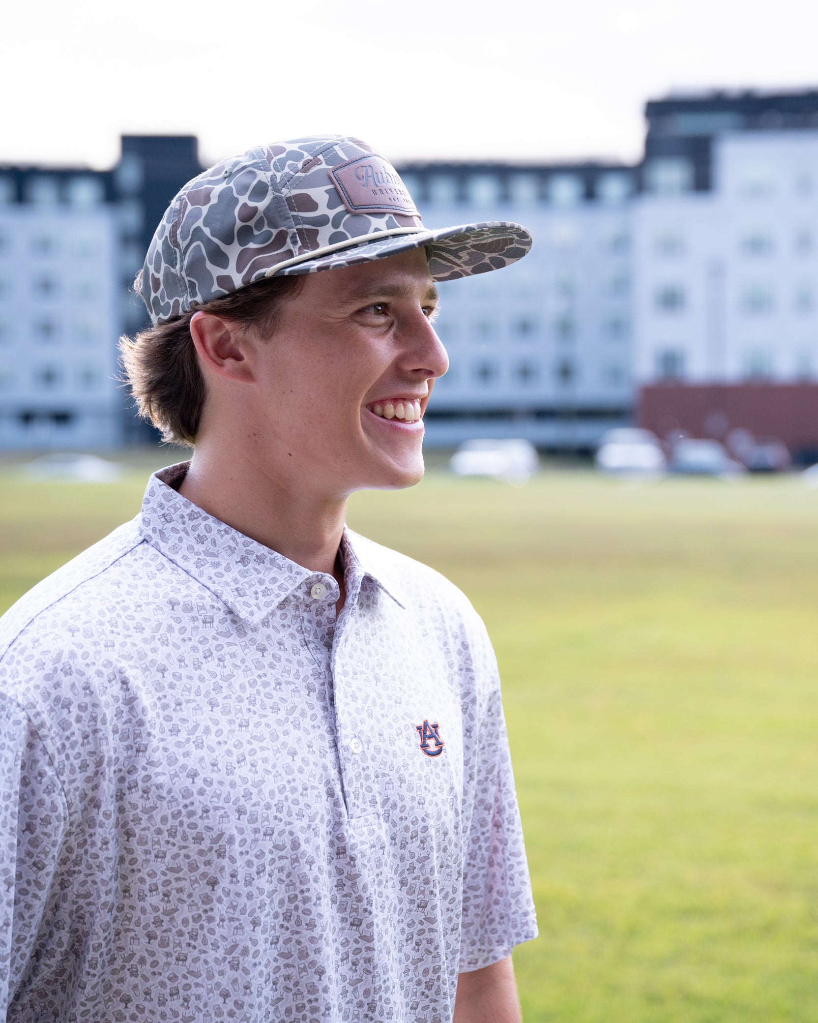 Auburn University AU Tailgate Polo (AU Logo) Grey Men's JNJ Performance Polo with a small Grey pattern of Drinks, Snacks, Grills, and Alabama states, etc.. and AU Logo Embroidery