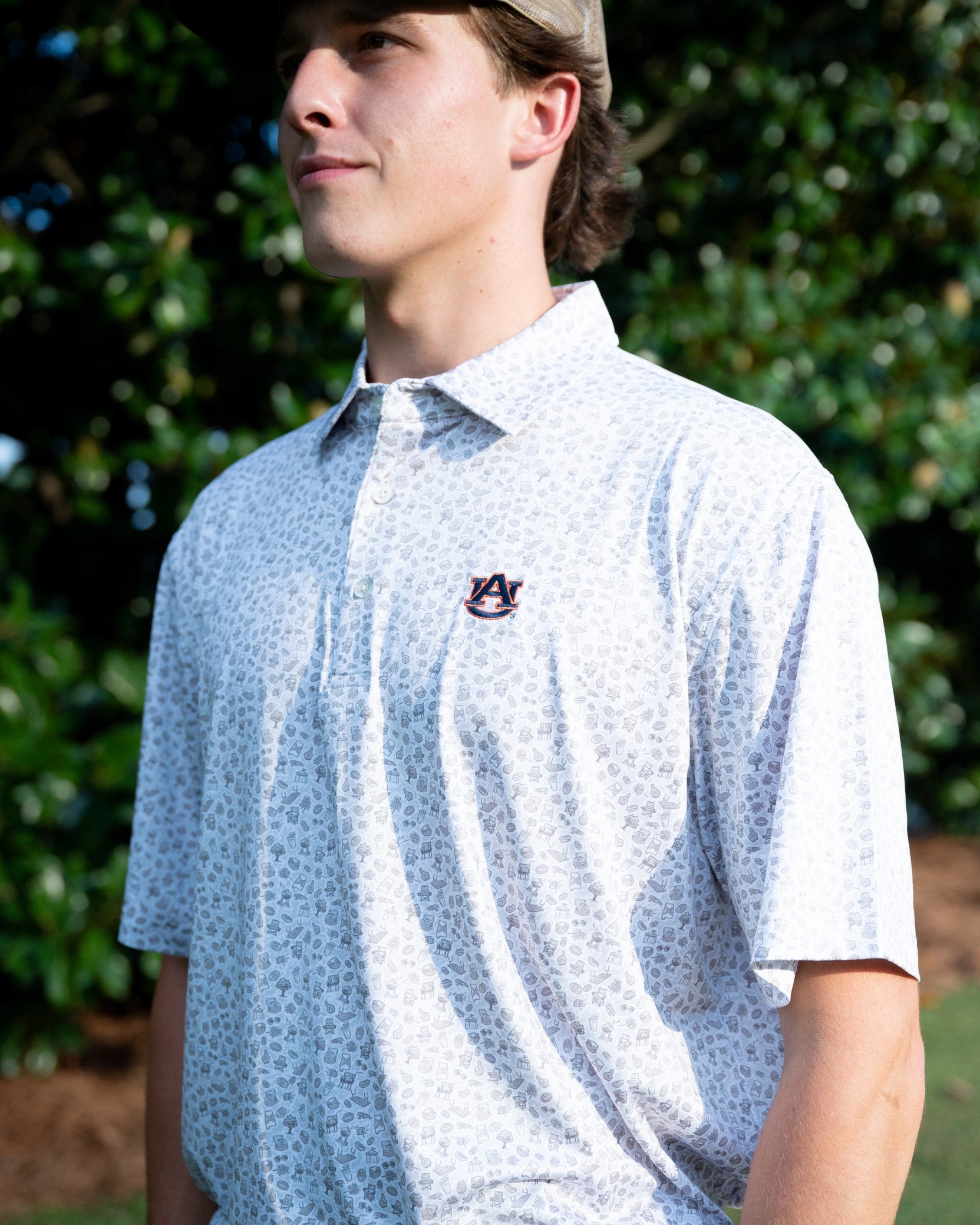 Auburn University AU Tailgate Polo (AU Logo) Grey Men's JNJ Performance Polo with a small Grey pattern of Drinks, Snacks, Grills, and Alabama states, etc.. and AU Logo Embroidery