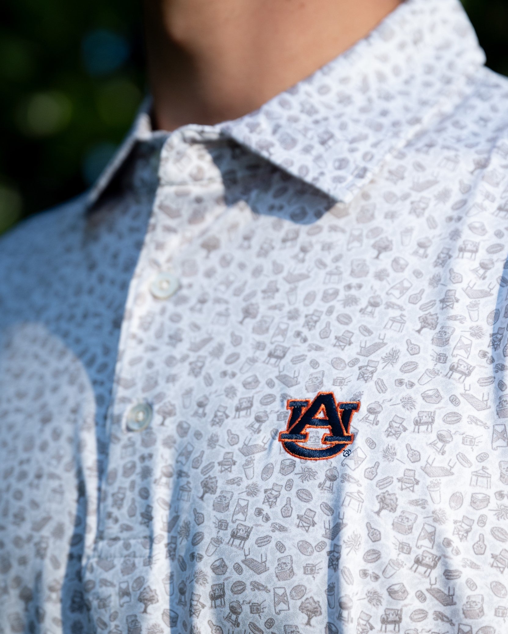 Auburn University AU Tailgate Polo (AU Logo) Grey Men's JNJ Performance Polo with a small Grey pattern of Drinks, Snacks, Grills, and Alabama states, etc.. and AU Logo Embroidery