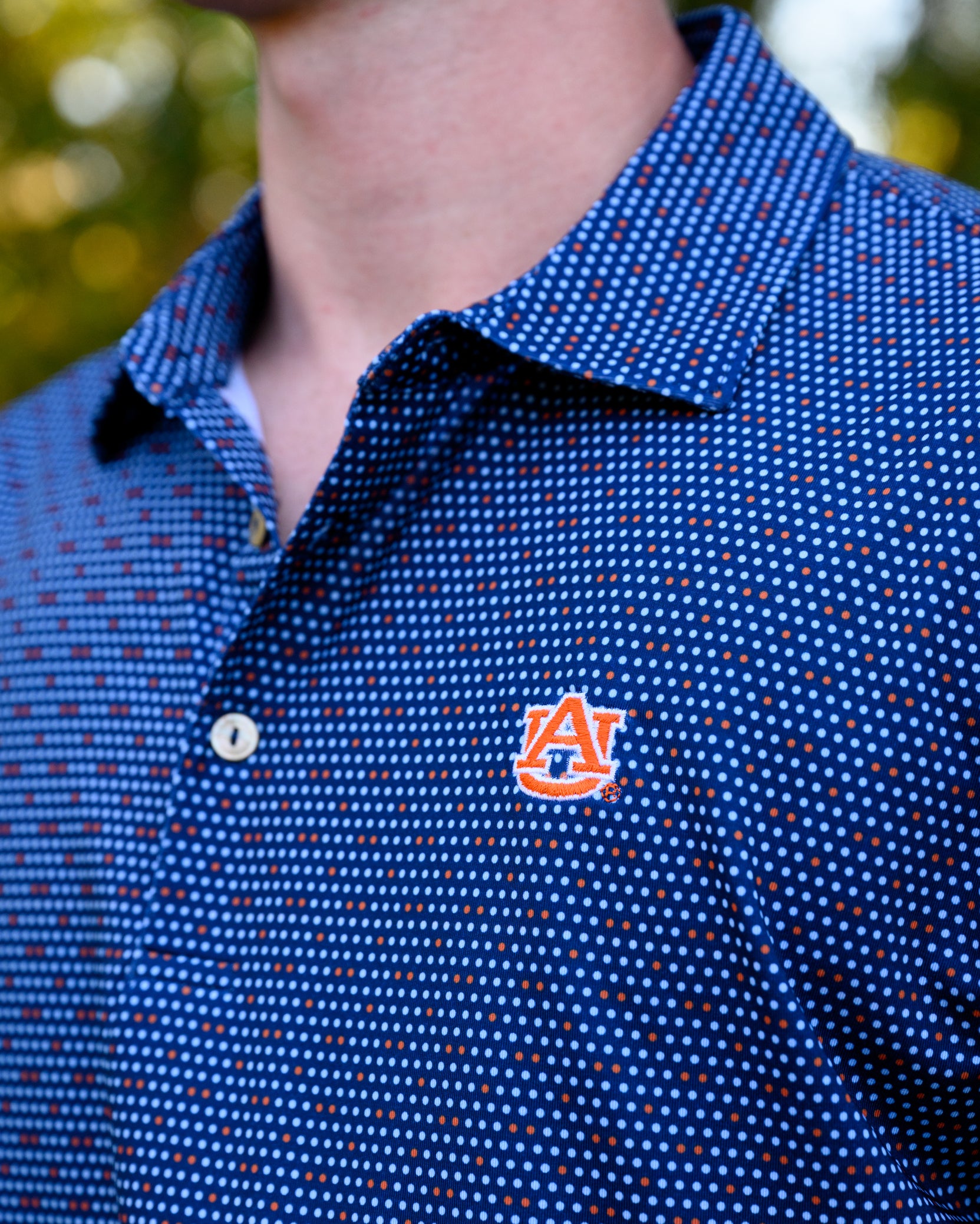 Auburn University AU Team Dot Polo (AU Logo) Navy Men's JNJ Performance Polo with a pattern of Light Blue and Orange Dots and AU Logo Embroidery