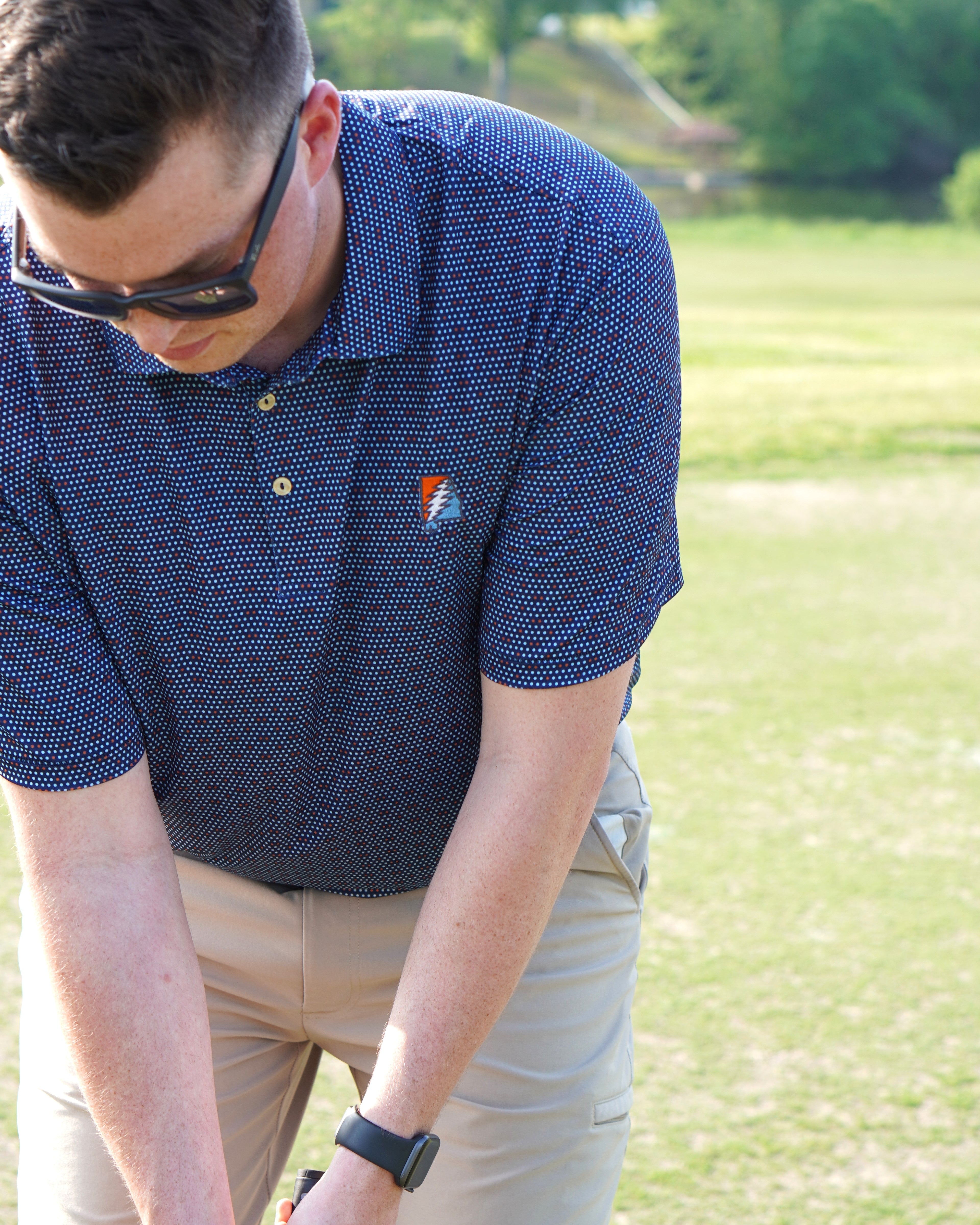 Auburn University AU Team Dot Polo (Grateful State) Navy Men's JNJ Performance Polo  with a pattern of Light Blue and Orange Dots and Embroidered Orange and Blue Grateful State Logo
