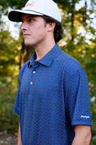 Auburn University Navy Men's Dot Polo with Light Blue and Orange dots and White "War Eagle" embroidery on the sleeve