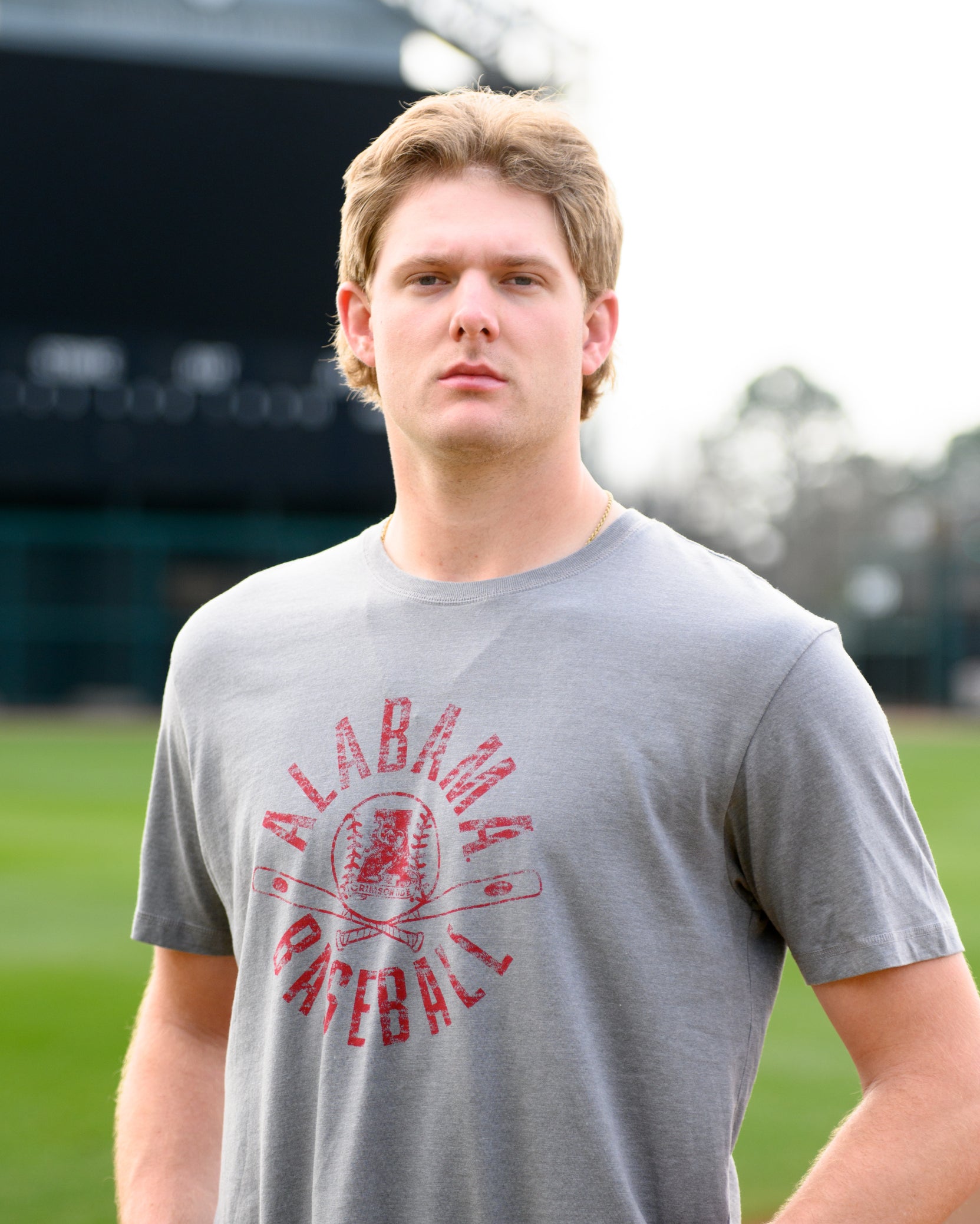 University of Alabama Distressed Grey T-Shirt with a Red Baseball featuring the Vintage A logo over crossed baseball bats, surrounded by White text “Alabama Baseball”