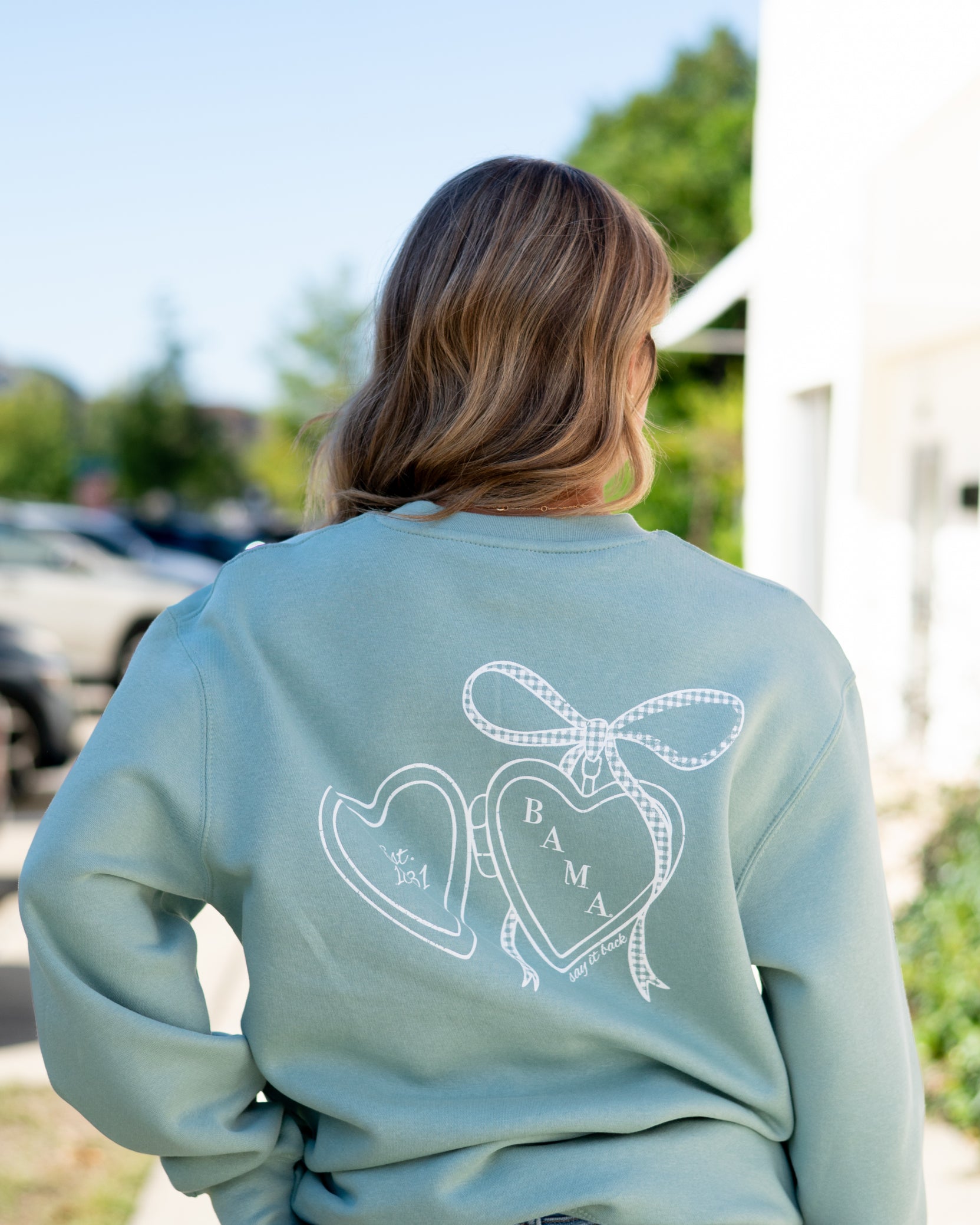 University of Alabama Seafoam Crewneck with cursive writing on the front and an open locket with the writing “Bama” inside on the back