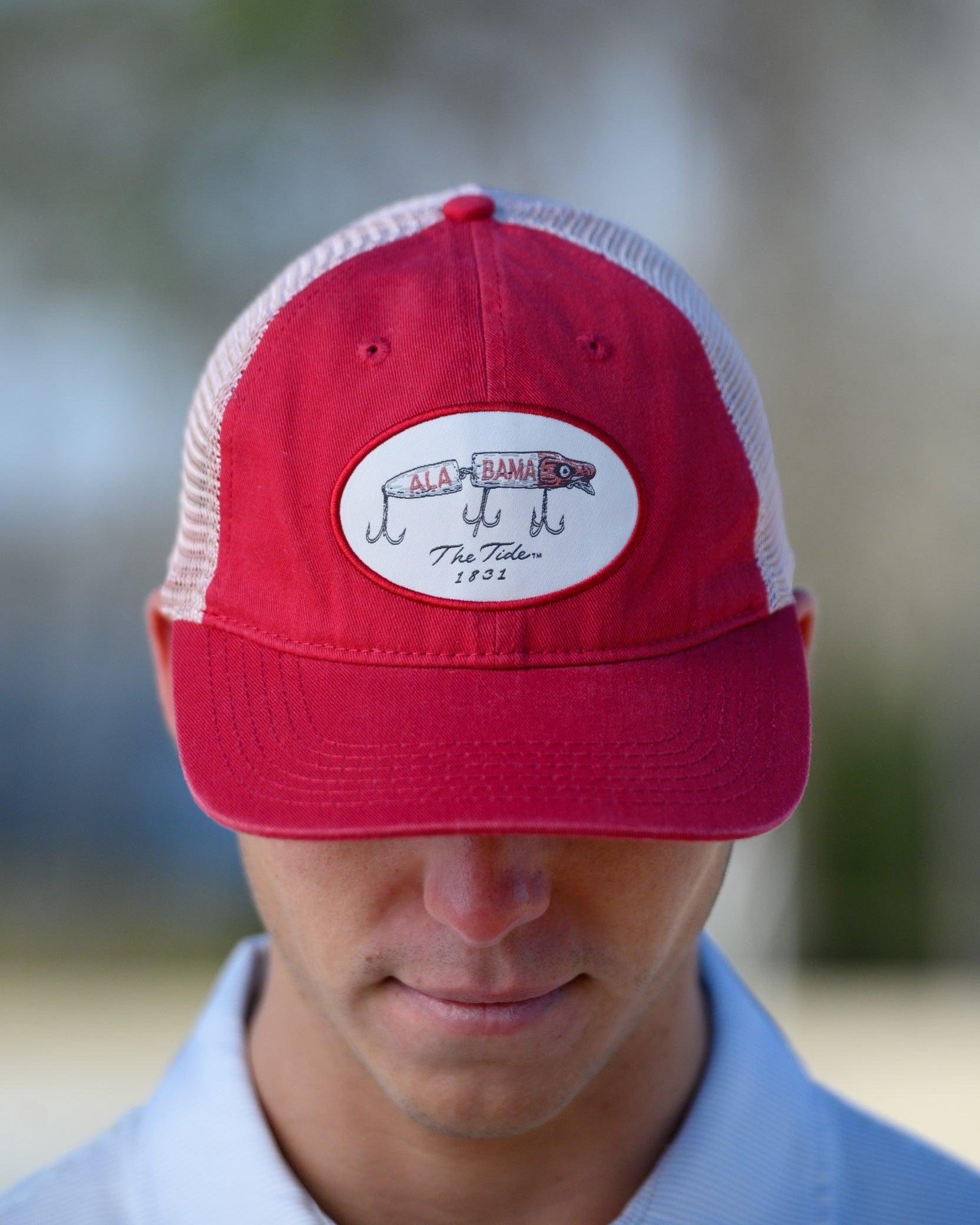 University of Alabama Red Trucker Hat featuring a patch with an image of a fishing lure with Red text "Alabama"