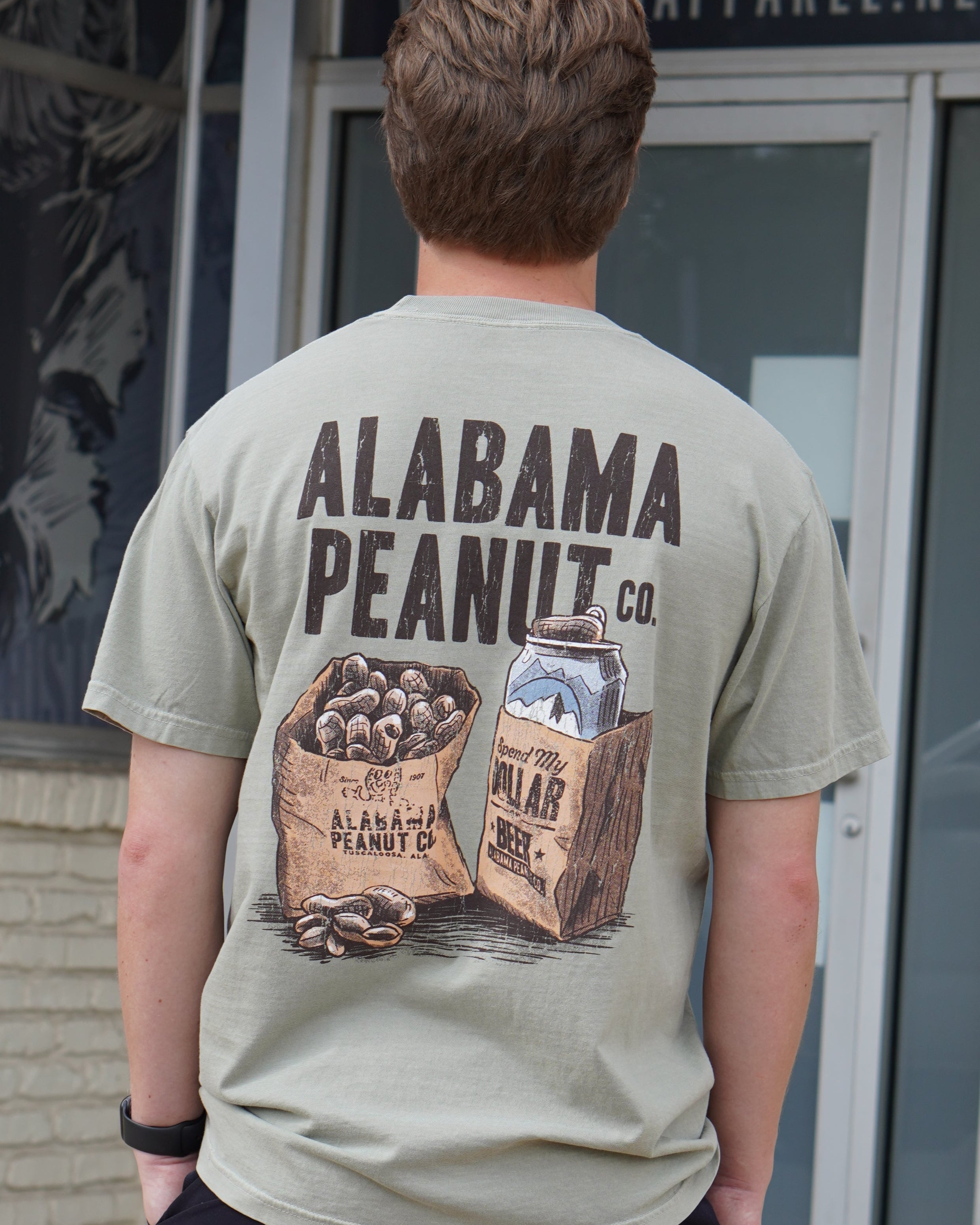 Alabama Peanut Co. Brown T-Shirt with an image of a bag of peanuts next to a beer can in a bag