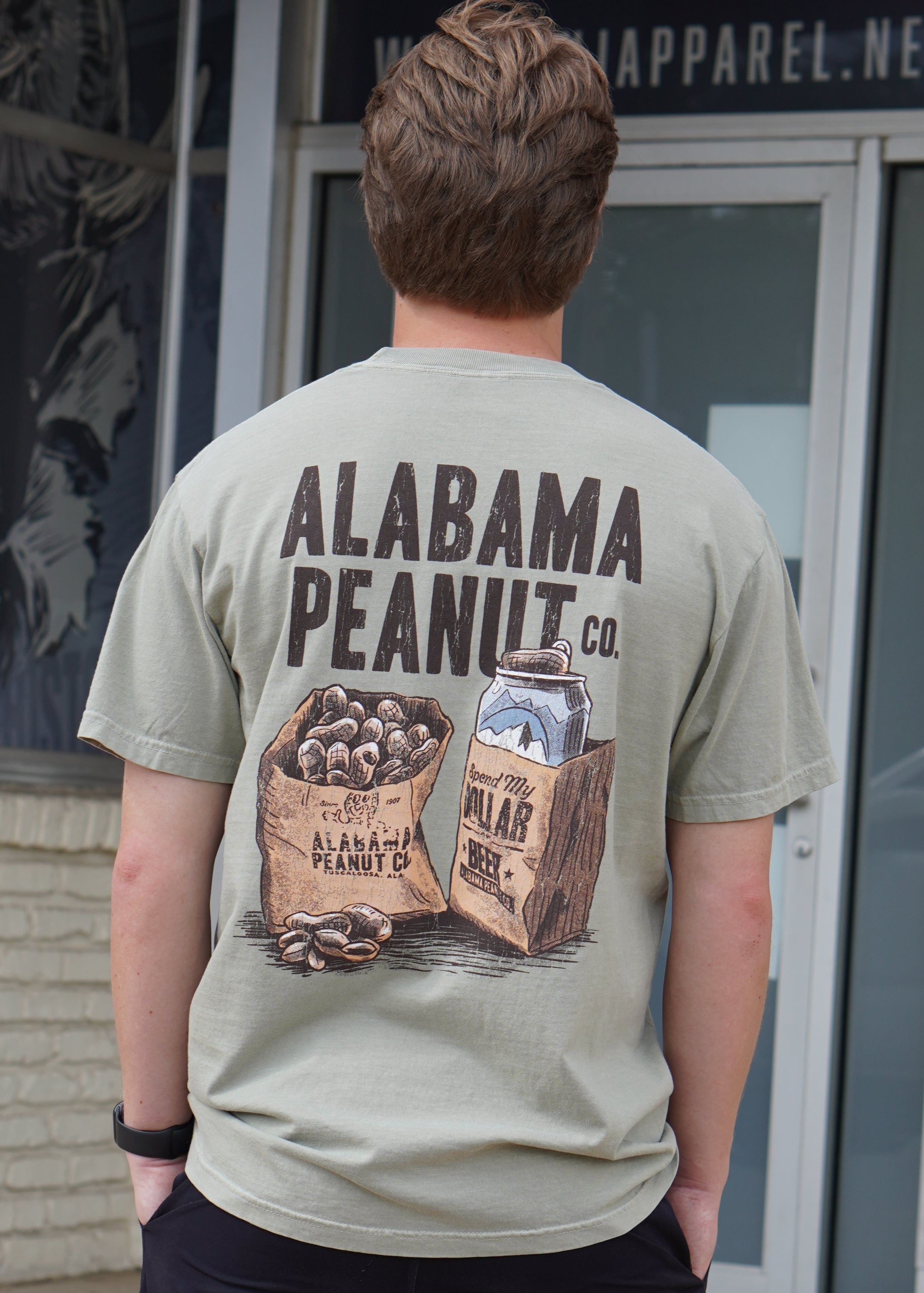 Alabama Peanut Co. Brown T-Shirt with an image of a bag of peanuts next to a beer can in a bag