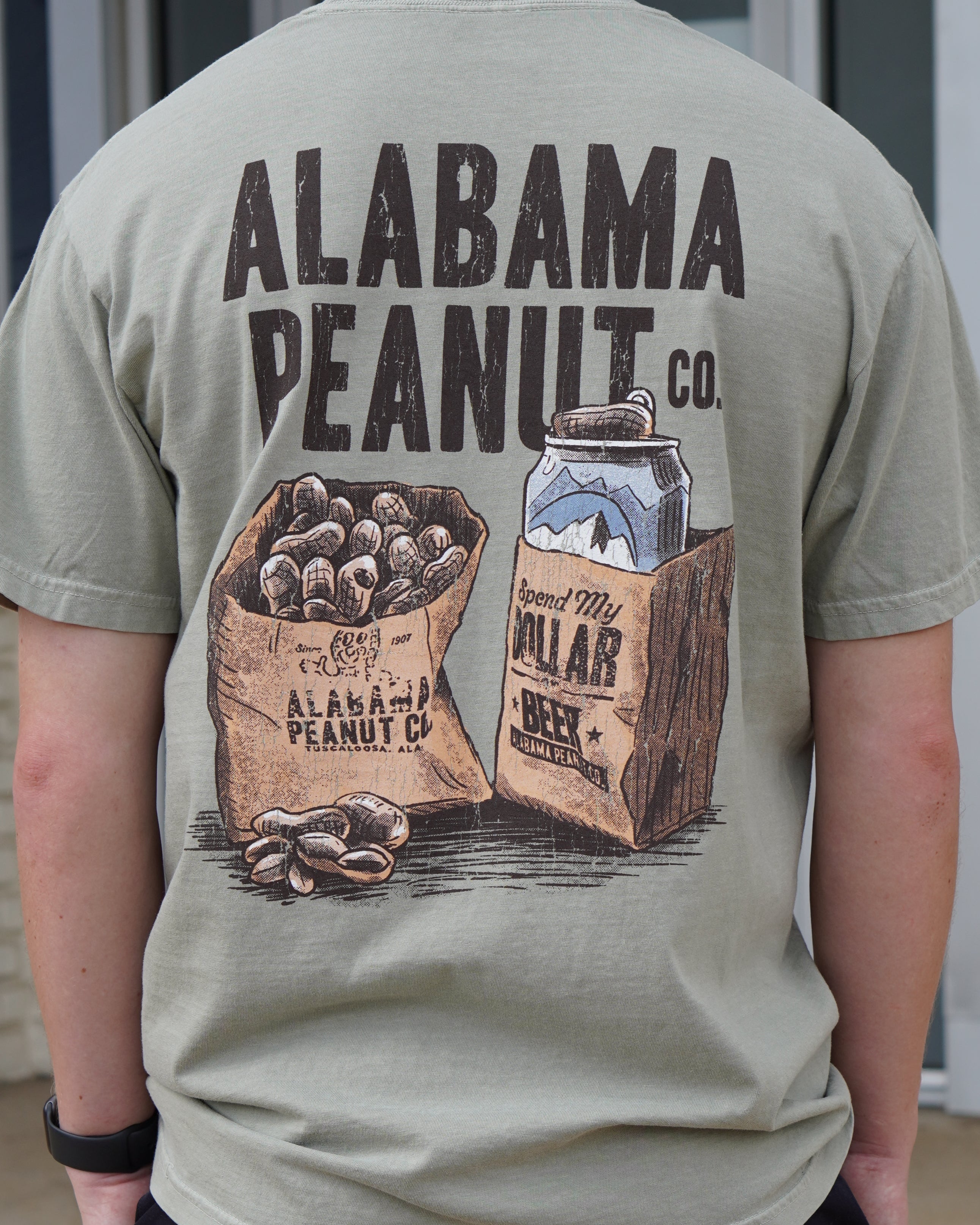 Alabama Peanut Co. Brown T-Shirt with an image of a bag of peanuts next to a beer can in a bag