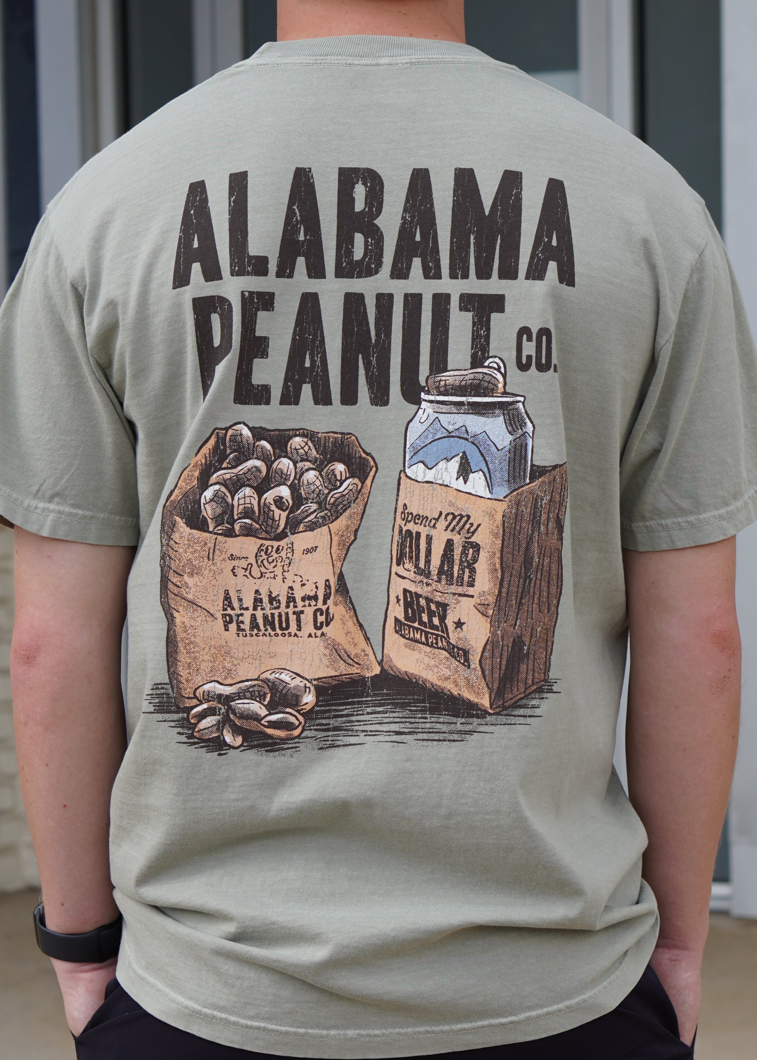 Alabama Peanut Co. Brown T-Shirt with an image of a bag of peanuts next to a beer can in a bag