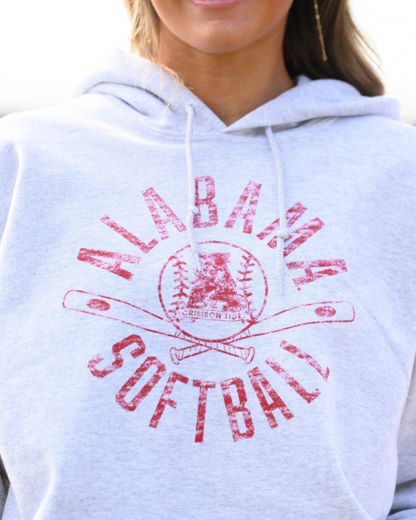 University of Alabama Distressed Light Grey Hoodie with a Red Softball featuring the Vintage A logo over crossed softball bats, surrounded by Red text “Alabama Softball”