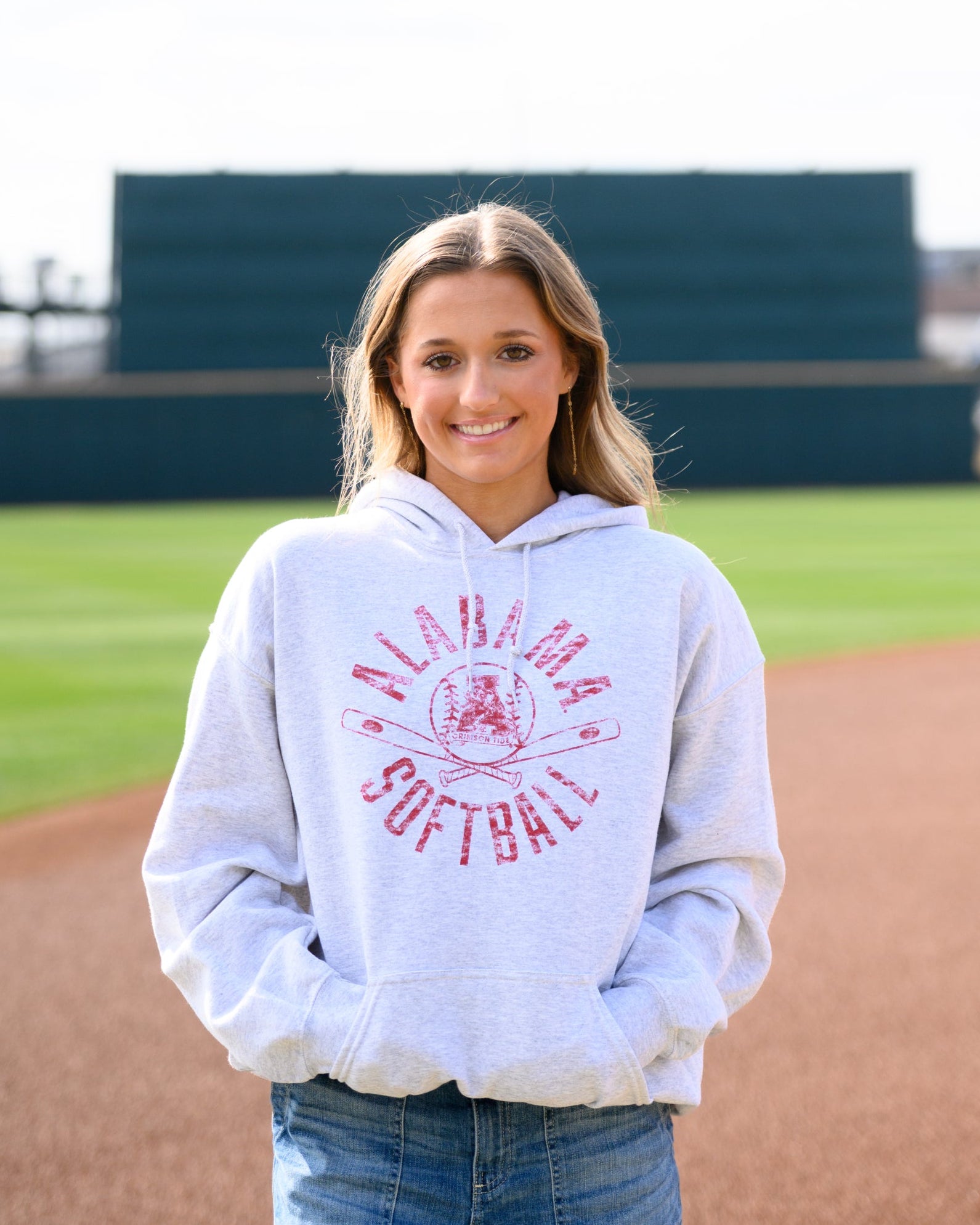 University of Alabama Distressed Light Grey Hoodie with a Red Softball featuring the Vintage A logo over crossed softball bats, surrounded by Red text “Alabama Softball”
