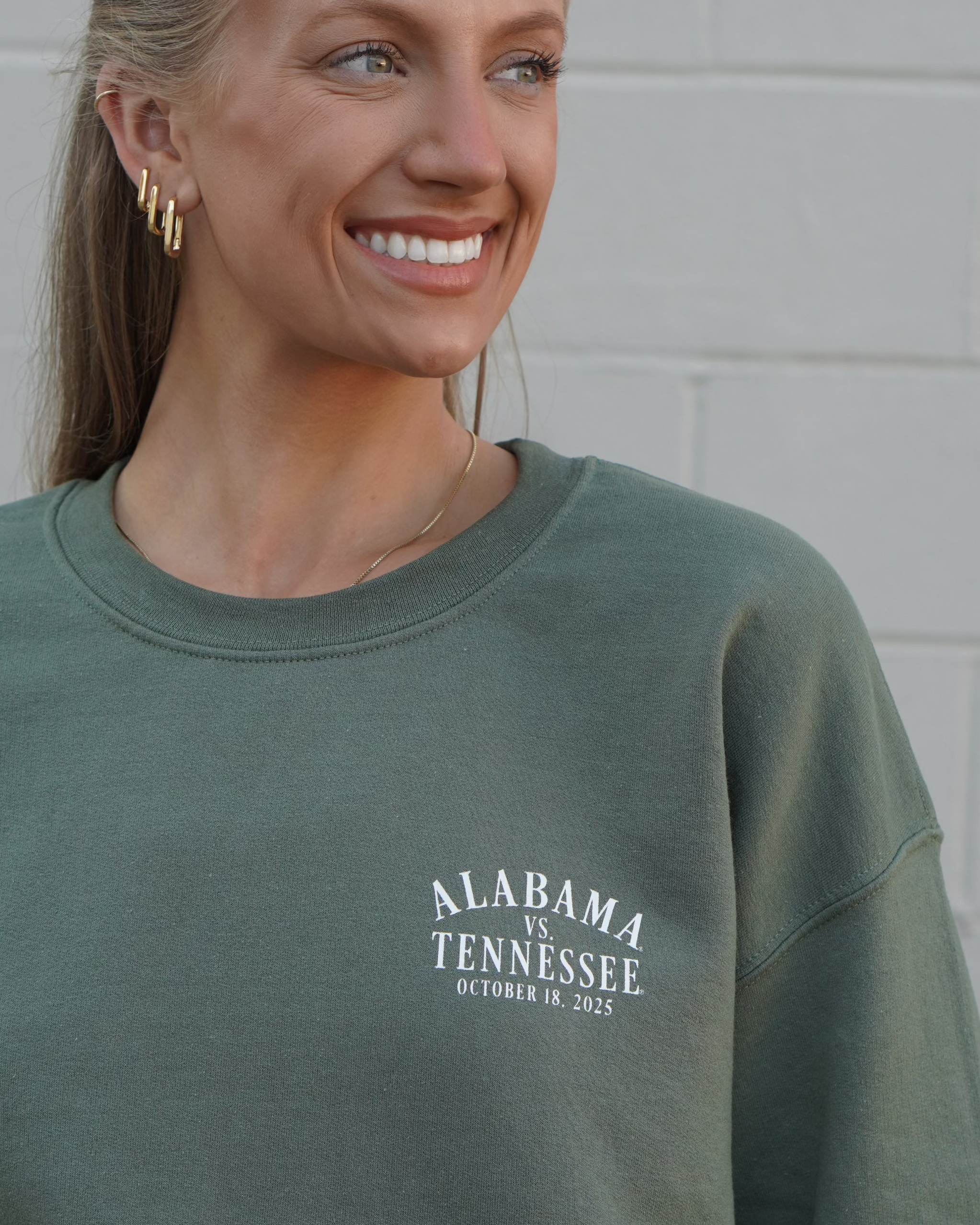University of Alabama Army Green Sweatshirt with an illustration of an elephant smashing Tennessee memorabilia