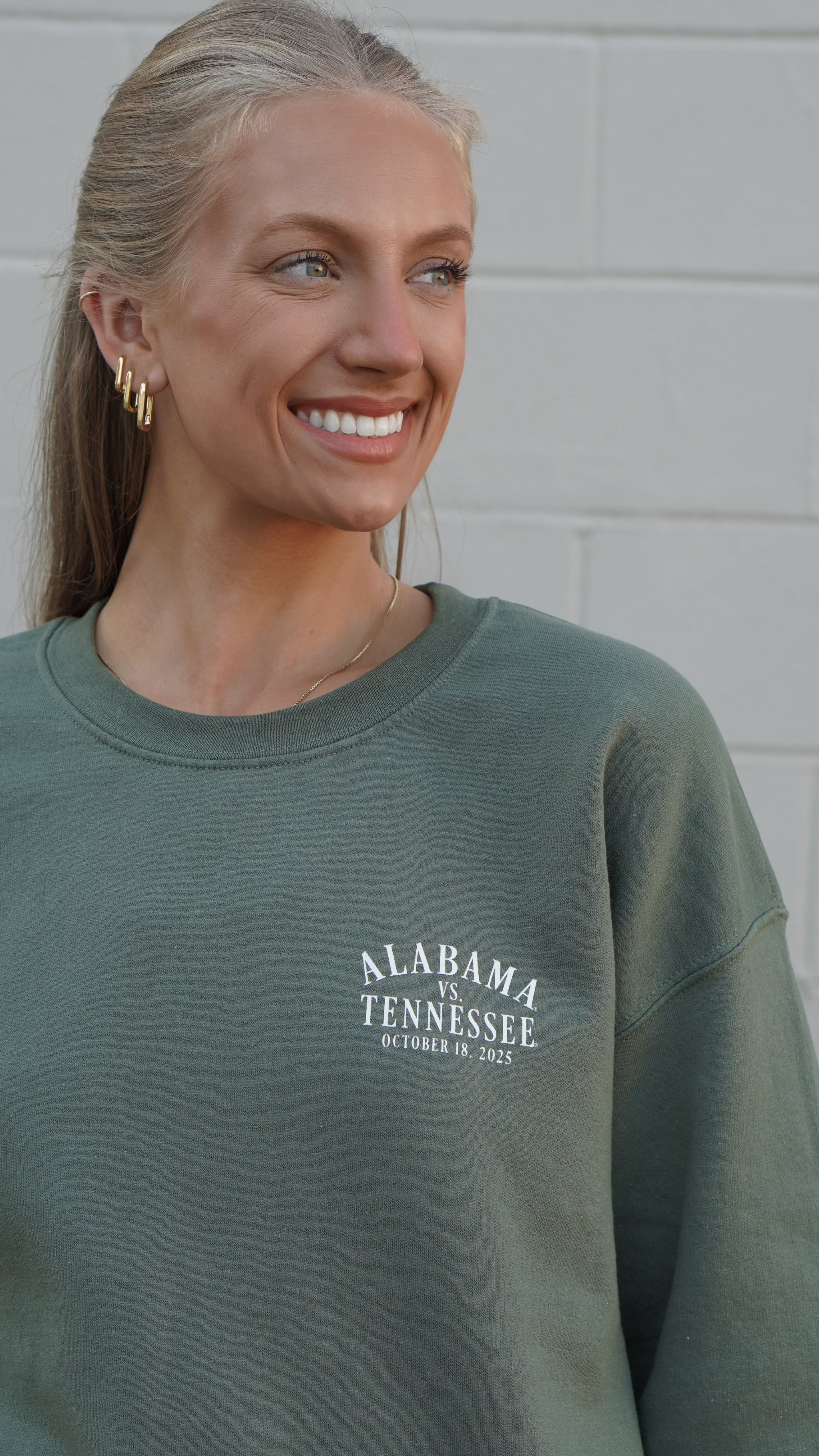 University of Alabama Army Green Sweatshirt with an illustration of an elephant smashing Tennessee memorabilia