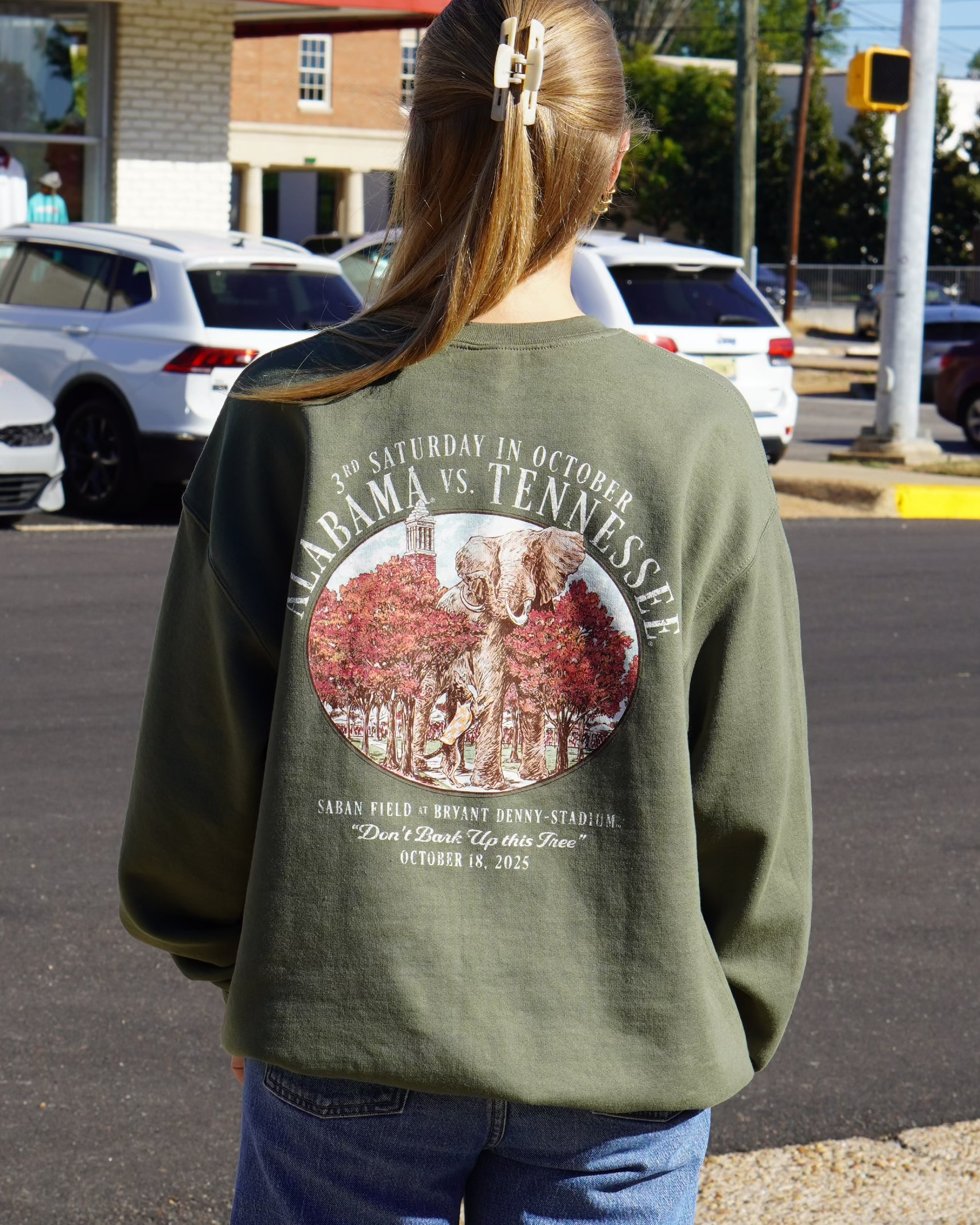 University of Alabama Army Green Sweatshirt with an illustration of an elephant smashing Tennessee memorabilia