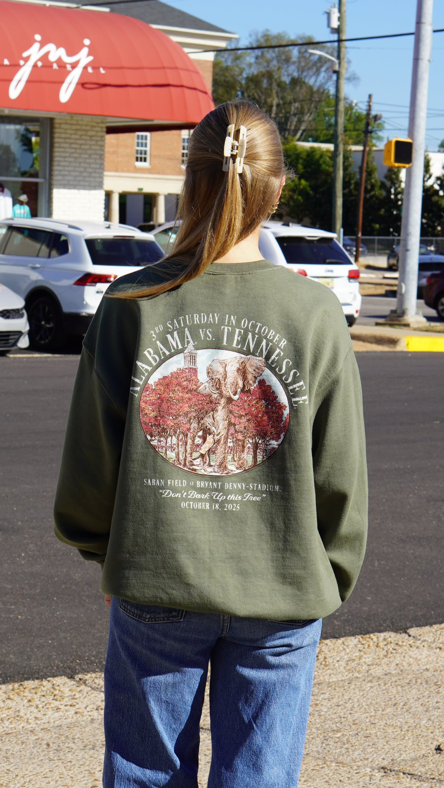 University of Alabama Army Green Sweatshirt with an illustration of an elephant smashing Tennessee memorabilia