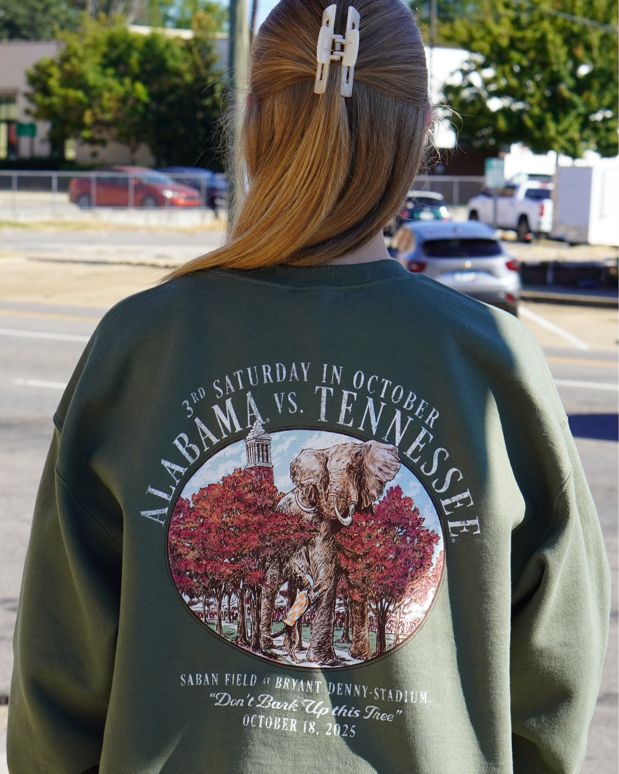 University of Alabama Army Green Sweatshirt with an illustration of an elephant smashing Tennessee memorabilia