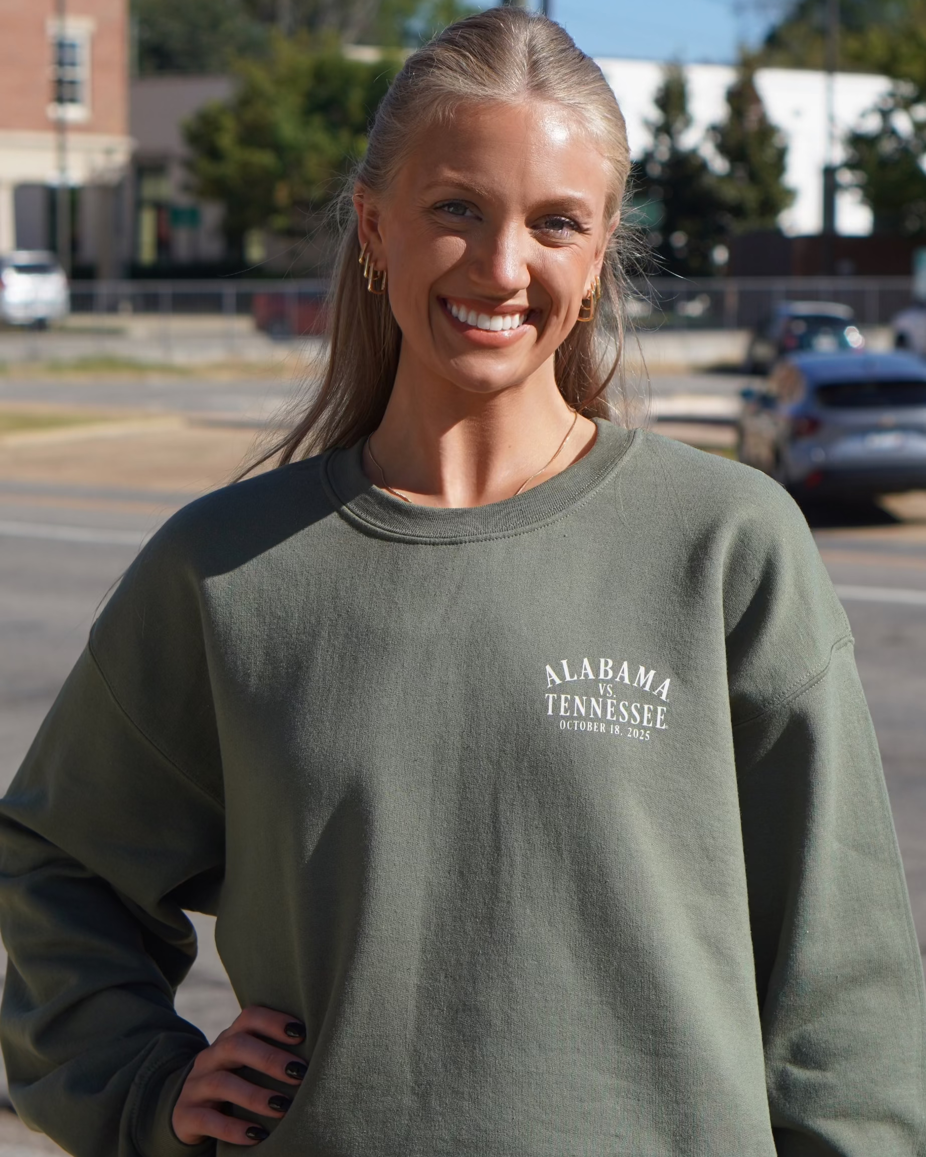 University of Alabama Army Green Sweatshirt with an illustration of an elephant smashing Tennessee memorabilia