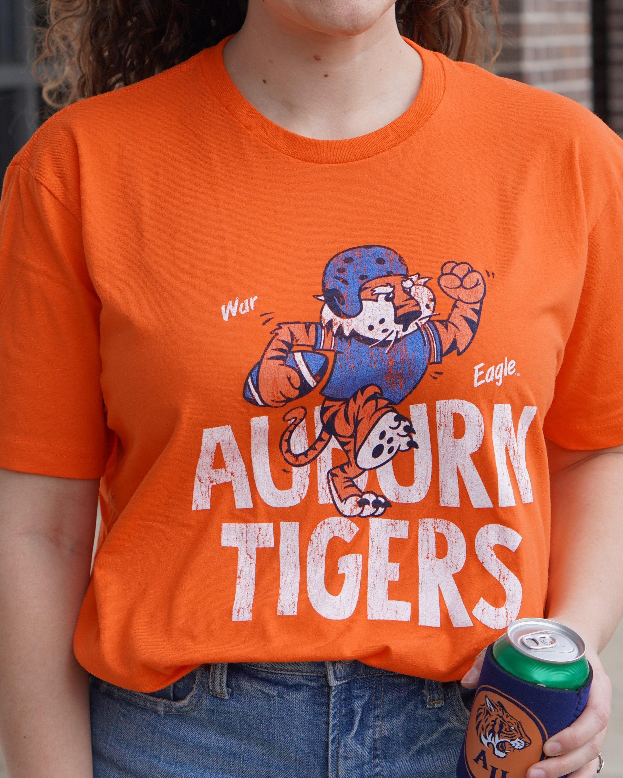 Auburn University All Auburn All Orange Bella Canvas Classic Orange T-Shirt with an image of Aubie the Tiger in a football uniform and holding a football on top of the text "Auburn Tigers"