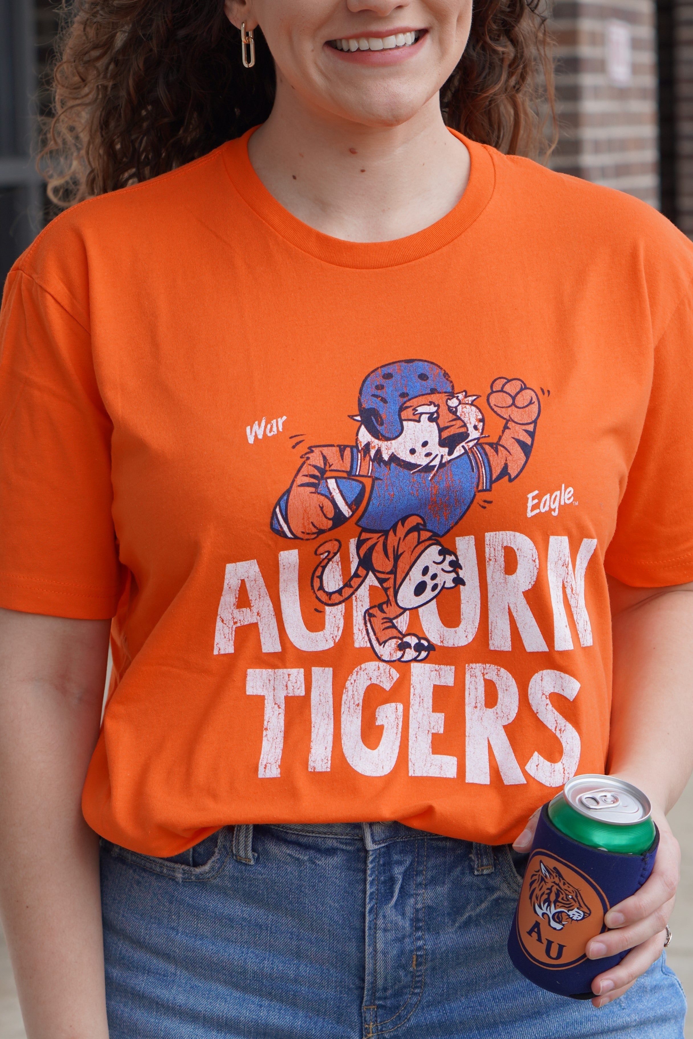 Auburn University All Auburn All Orange Bella Canvas Classic Orange T-Shirt with an image of Aubie the Tiger in a football uniform and holding a football on top of the text "Auburn Tigers"