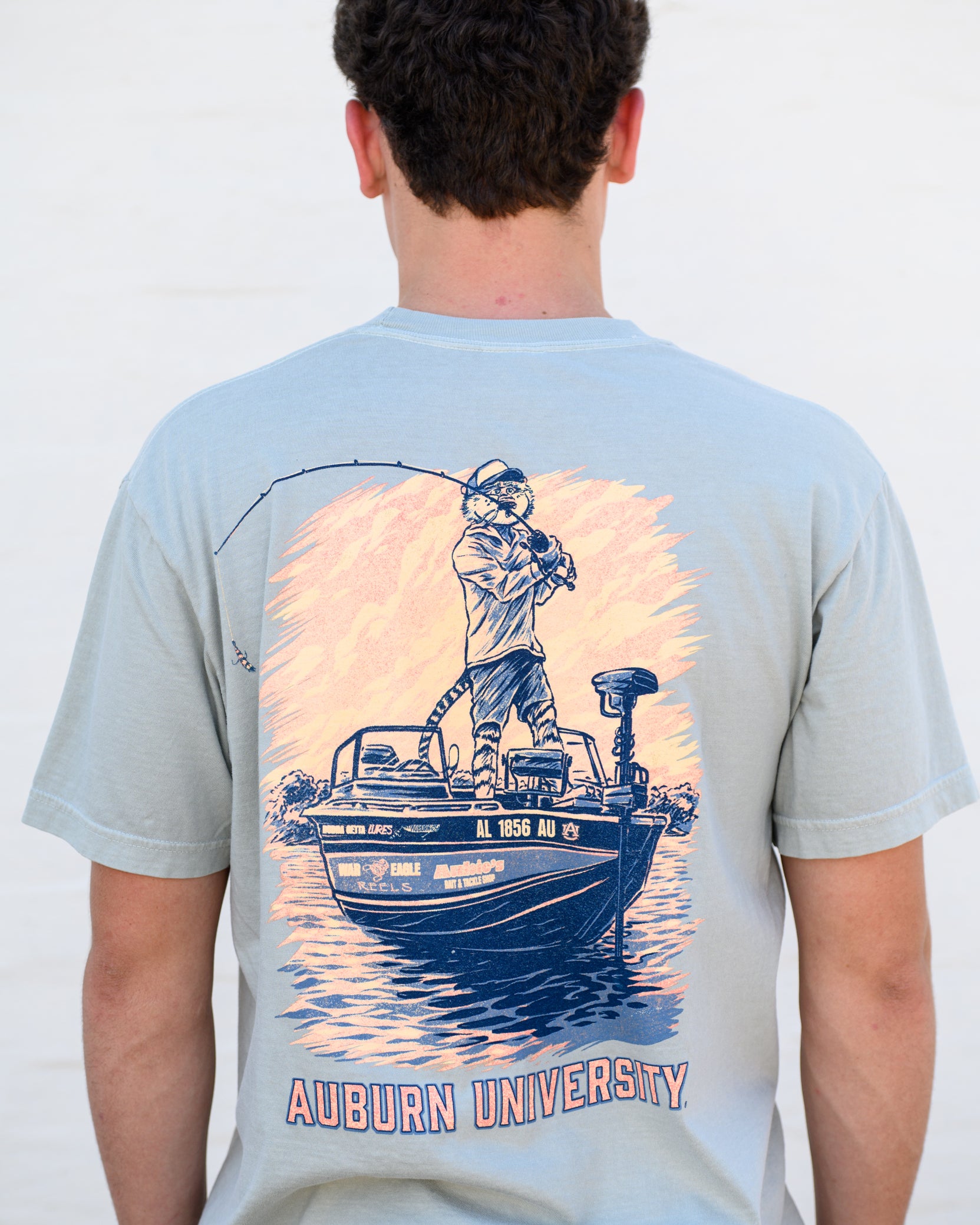 Auburn University Light Green T-Shirt with an image of Aubie bass fishing in a boat