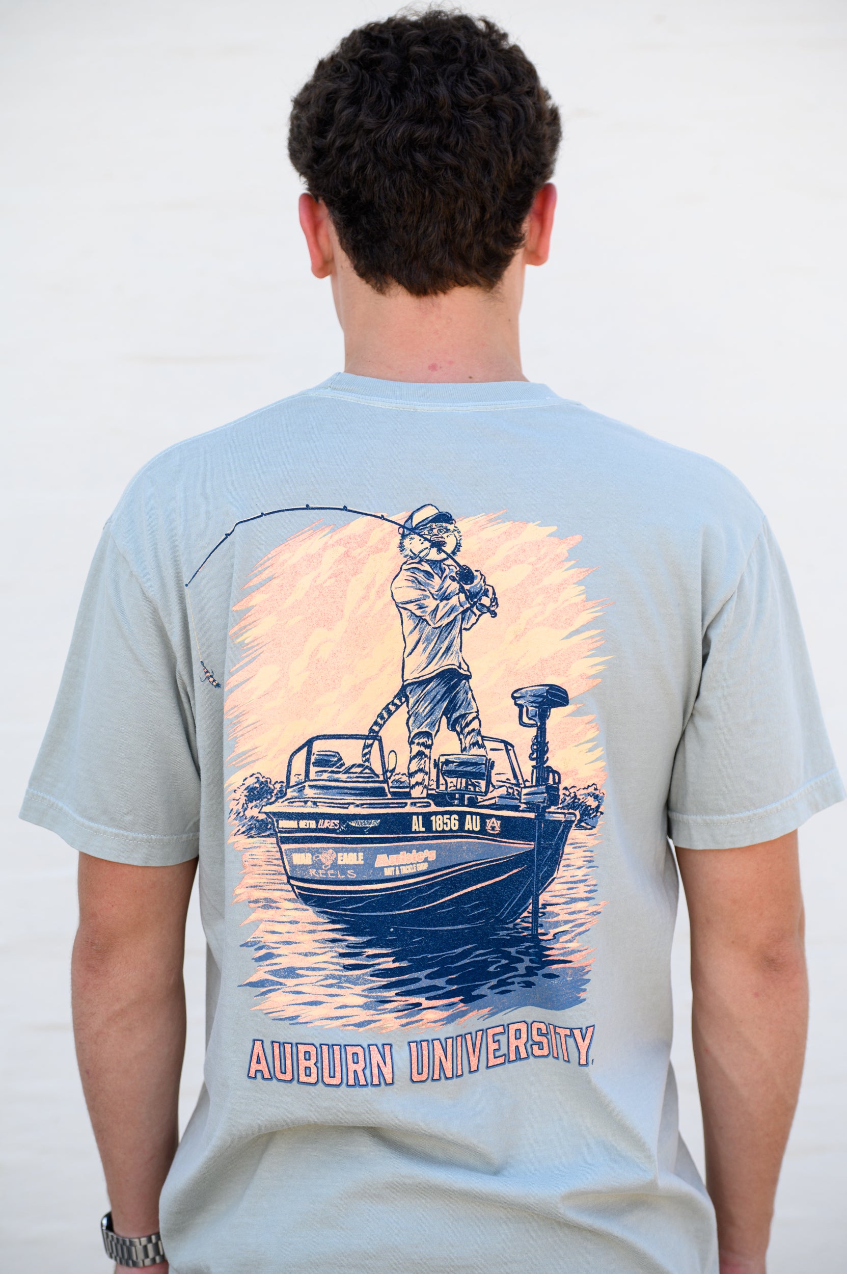 Auburn University Light Green T-Shirt with an image of Aubie bass fishing in a boat