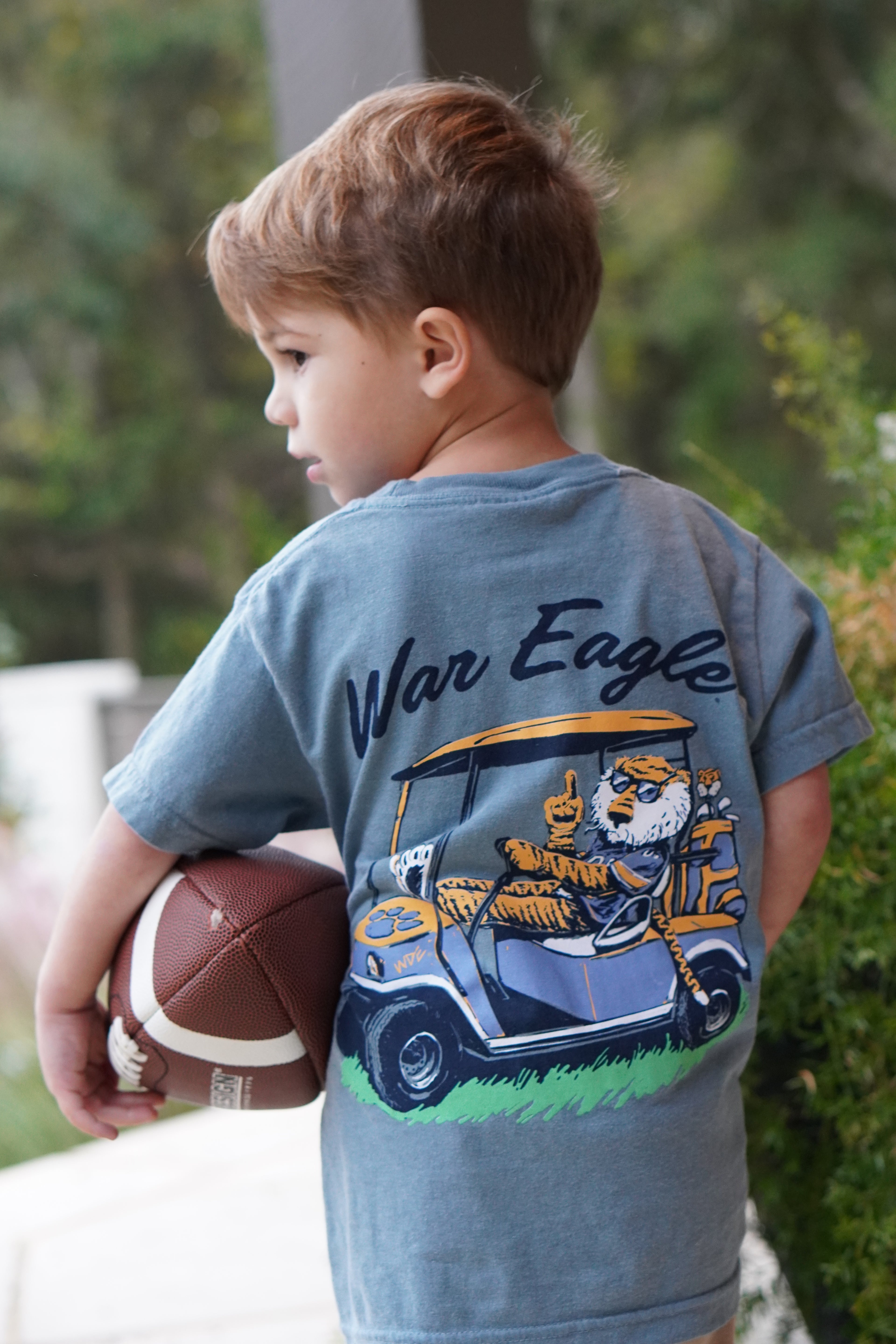 Auburn University Aubie Golf Cart Ice Blue Comfort Colors T-Shirt  with the text "War Eagle" above an image of Aubie the Tiger wearing sunglasses and driving a golf cart