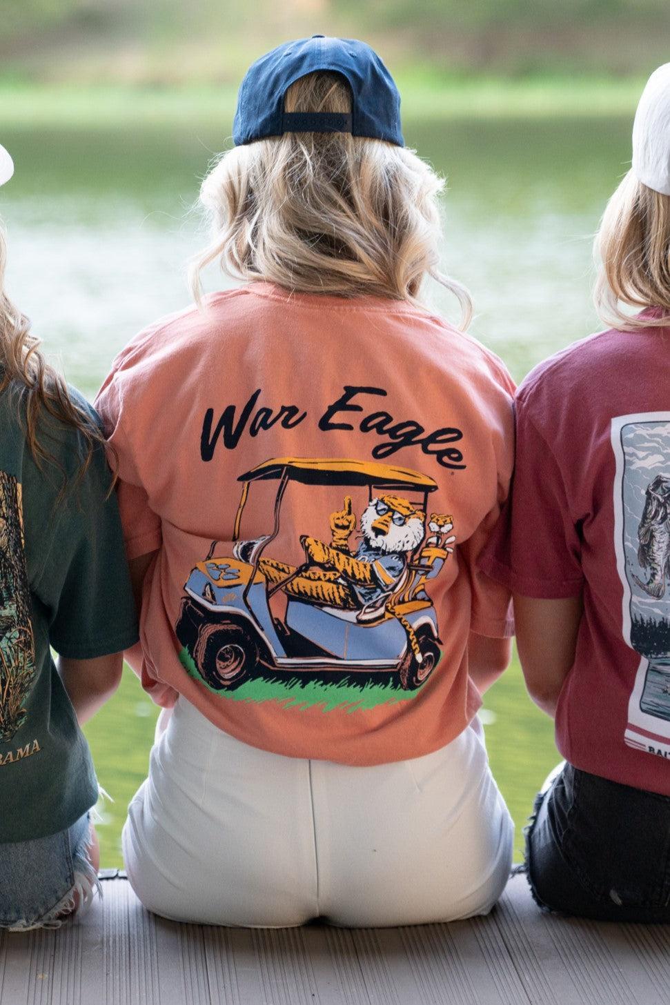 Auburn University Aubie Golf Cart Terracotta Comfort Colors T-Shirt with the text "War Eagle" above an image of Aubie the Tiger wearing sunglasses and driving a golf cart
