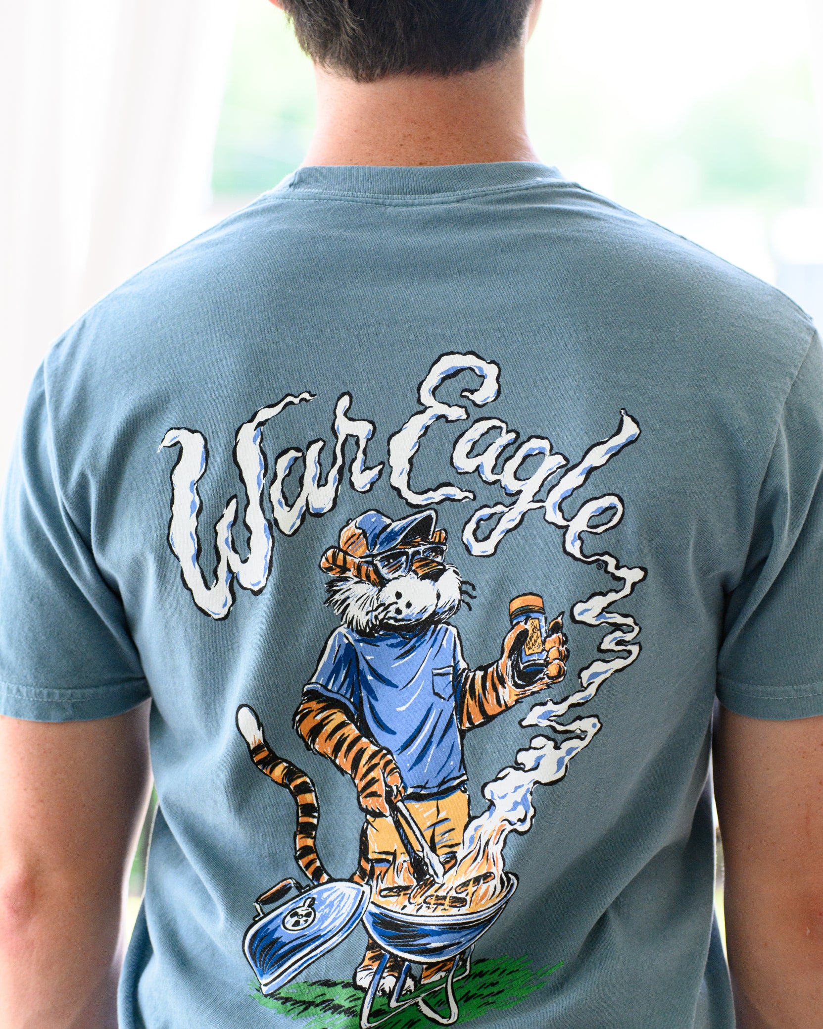 Auburn University Blue T-Shirt with a drawing of Aubie grilling and the words “War Eagle” written in the smoke