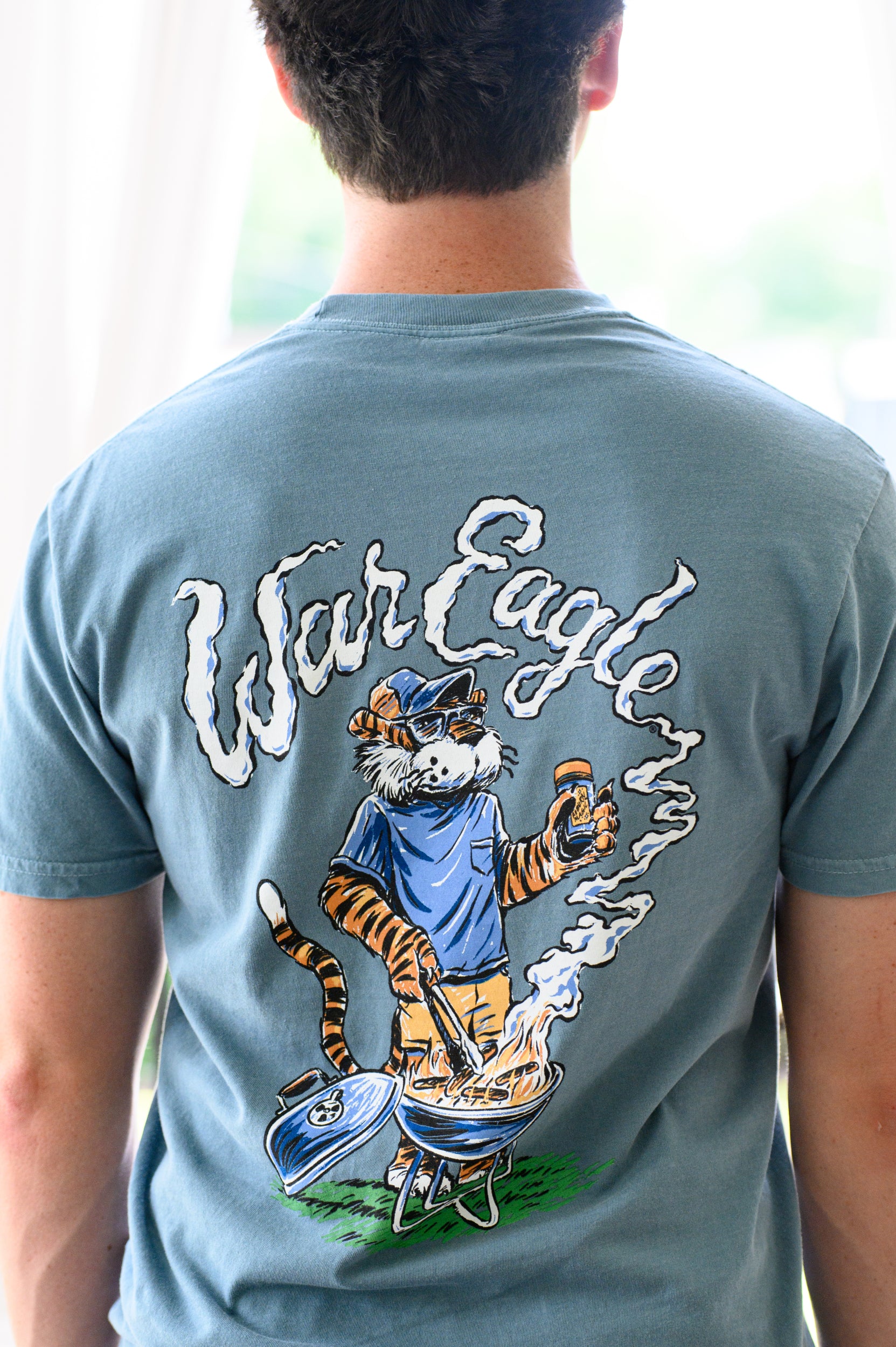 Auburn University Blue T-Shirt with a drawing of Aubie grilling and the words “War Eagle” written in the smoke
