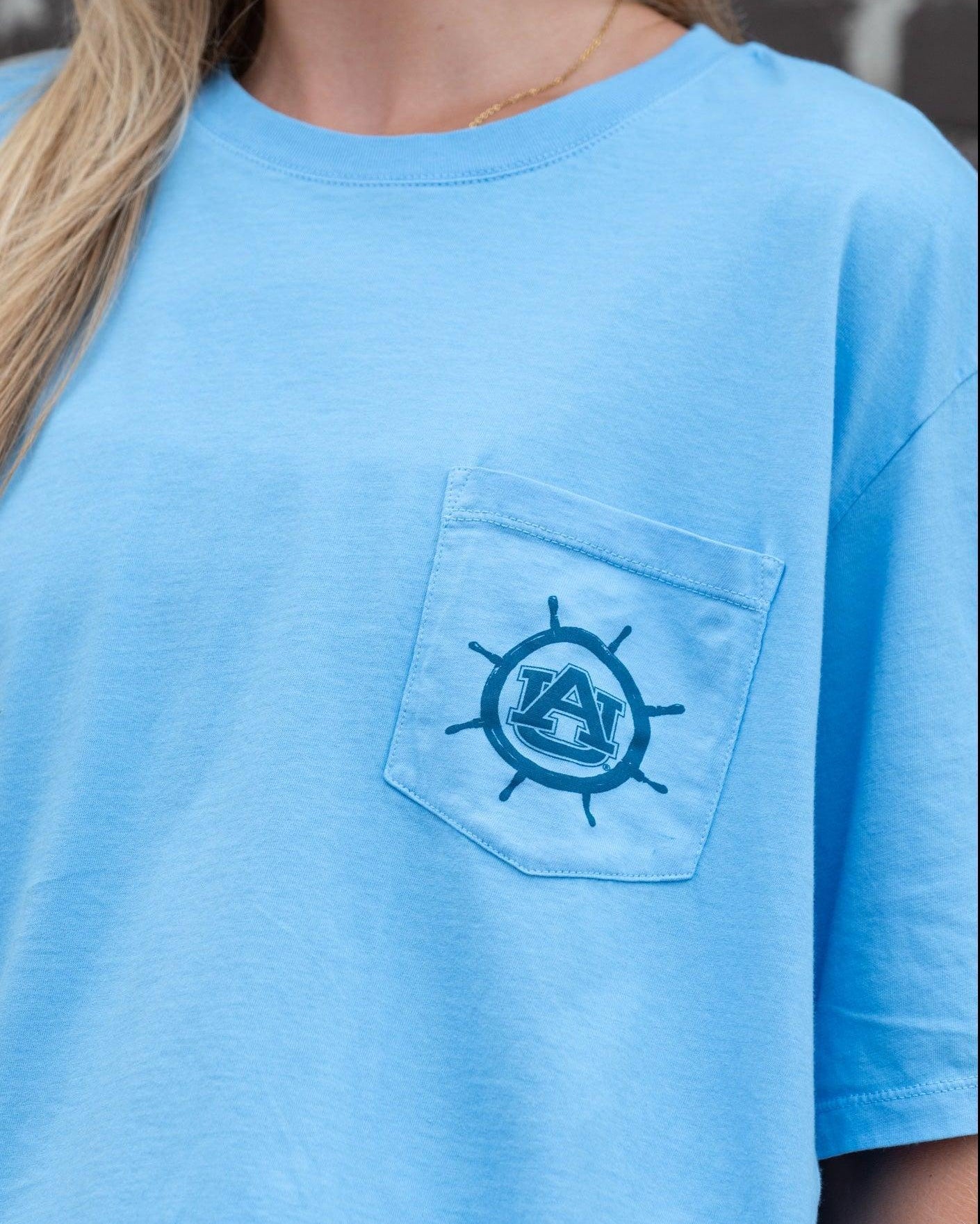 Auburn University Blue Shirt with a Front Pocket featuring a ships wheel circling the classic AU Logo