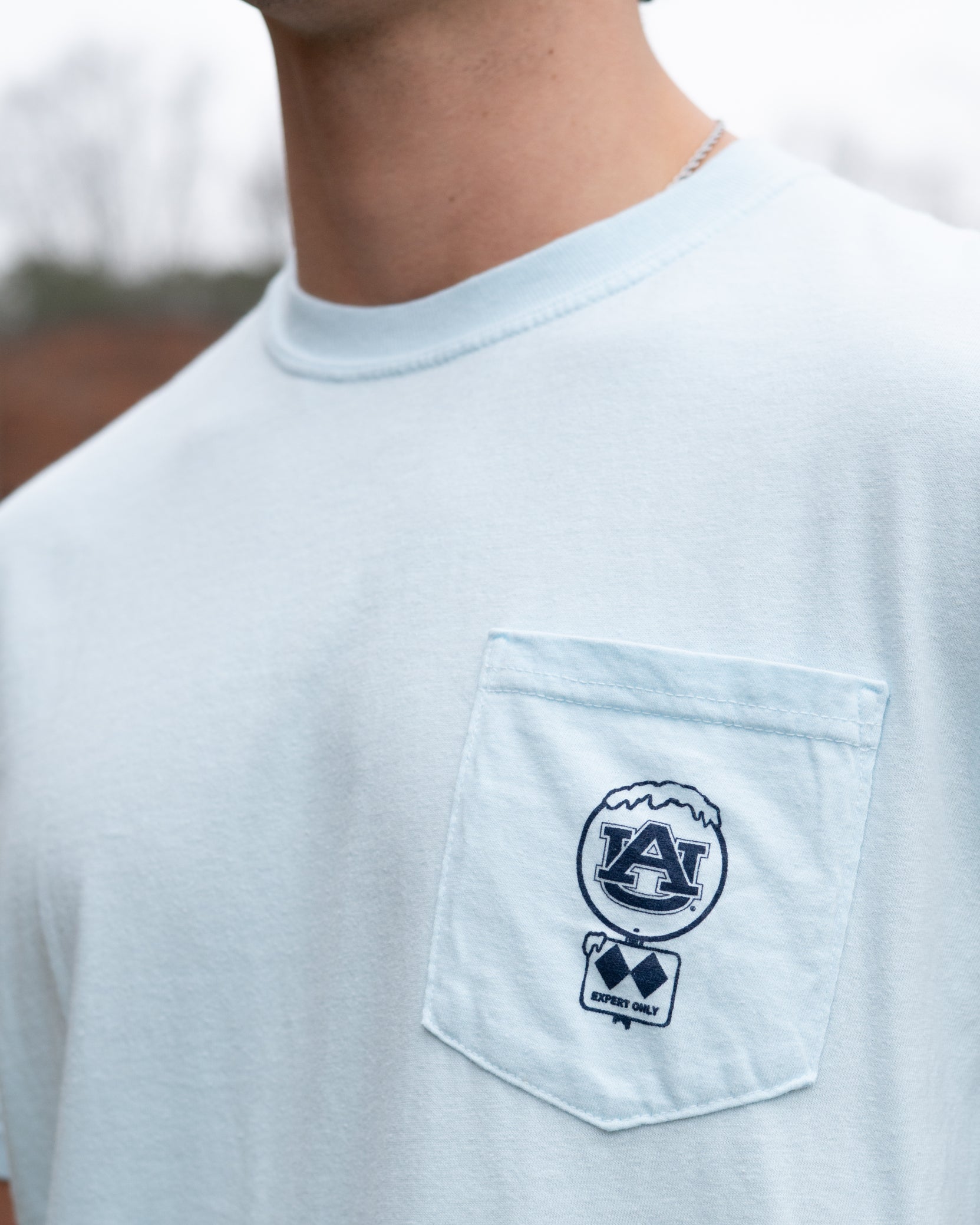 Auburn University Light Blue T-Shirt with a snow-covered Classic AU Logo on the front pocket