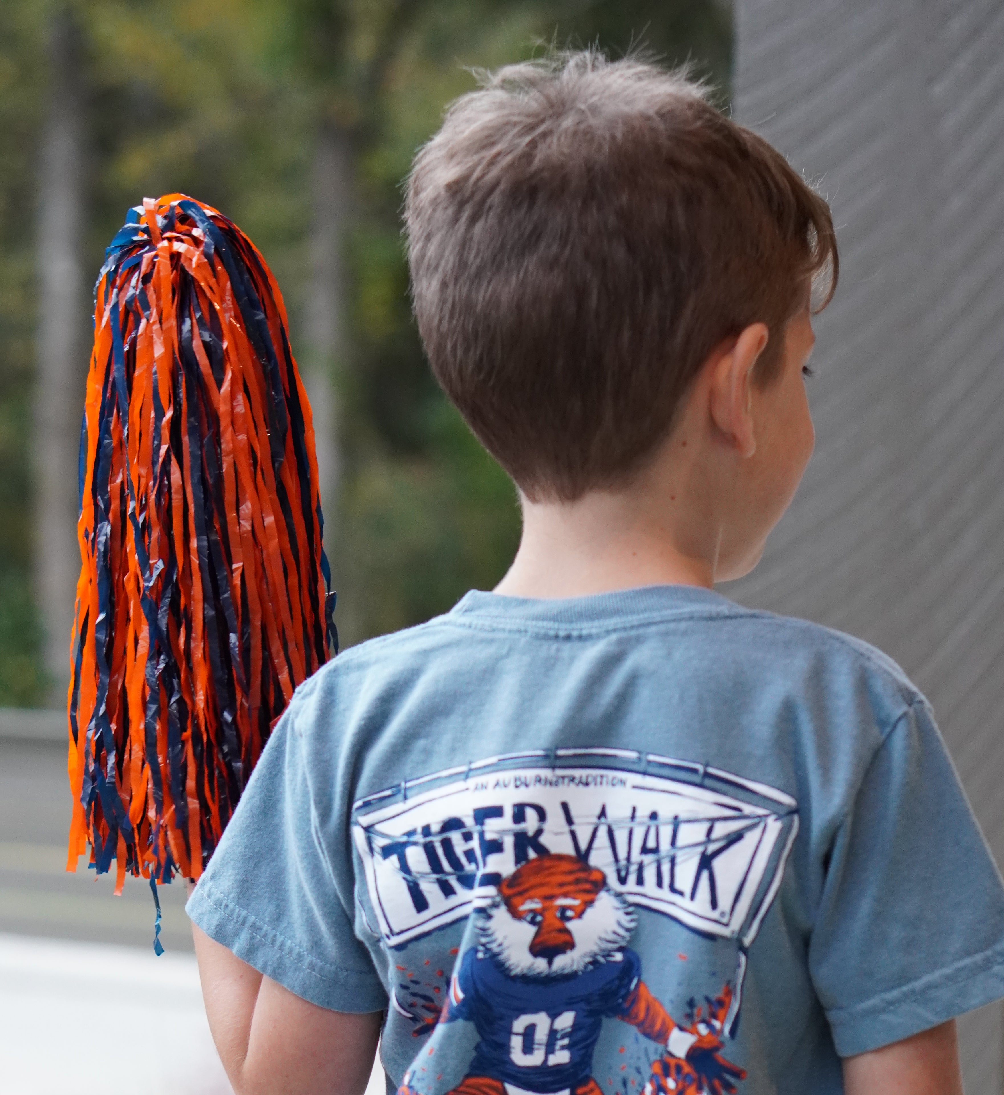 Auburn University Aubie Tiger Walk Ice Blue Gildan Youth Tee with an image of Aubie the Tiger leading a parade under a banner with the text "Tiger Walk"