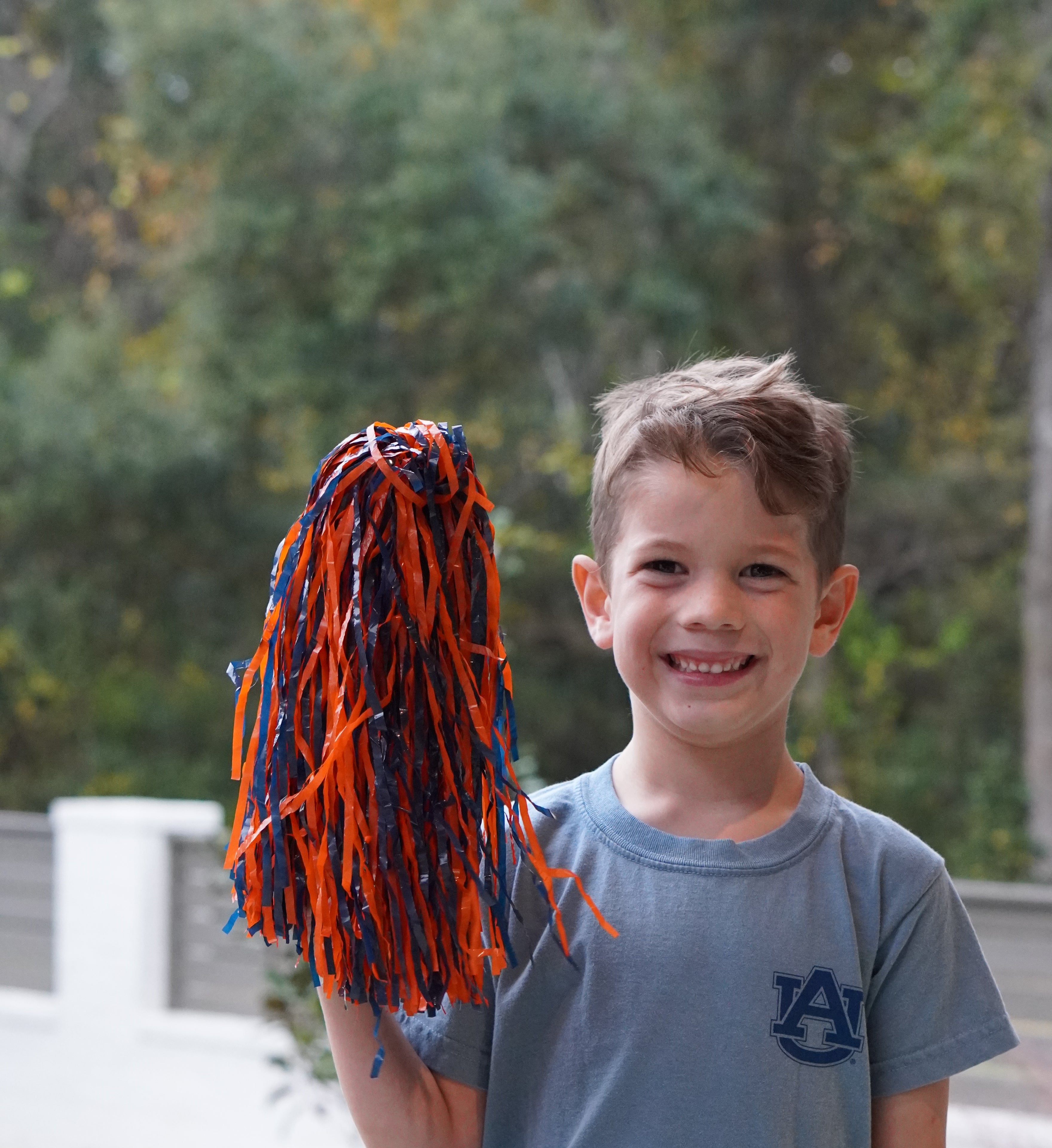 Auburn University Aubie Tiger Walk Ice Blue Gildan Youth Tee with an image of Aubie the Tiger leading a parade under a banner with the text "Tiger Walk"