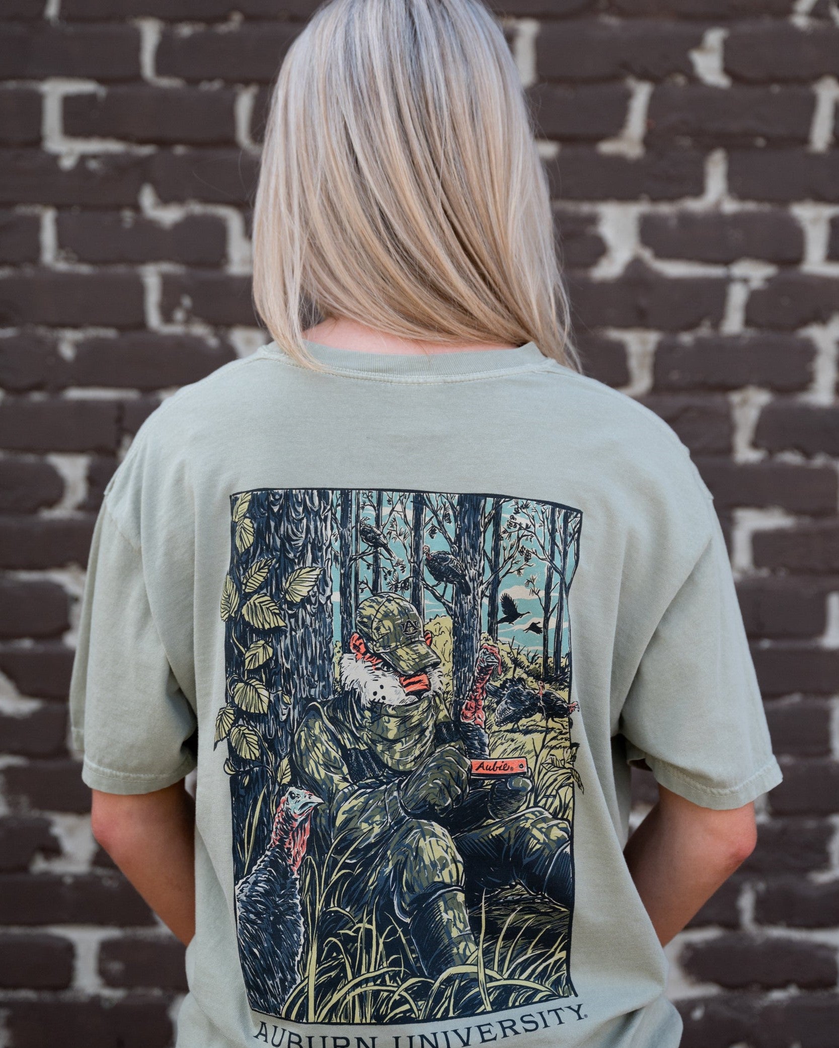 Auburn University Aubie Turkey Call Comfort Colors Bay with an image of Aubie the Tiger wearing hunting gear and sitting next to turkeys