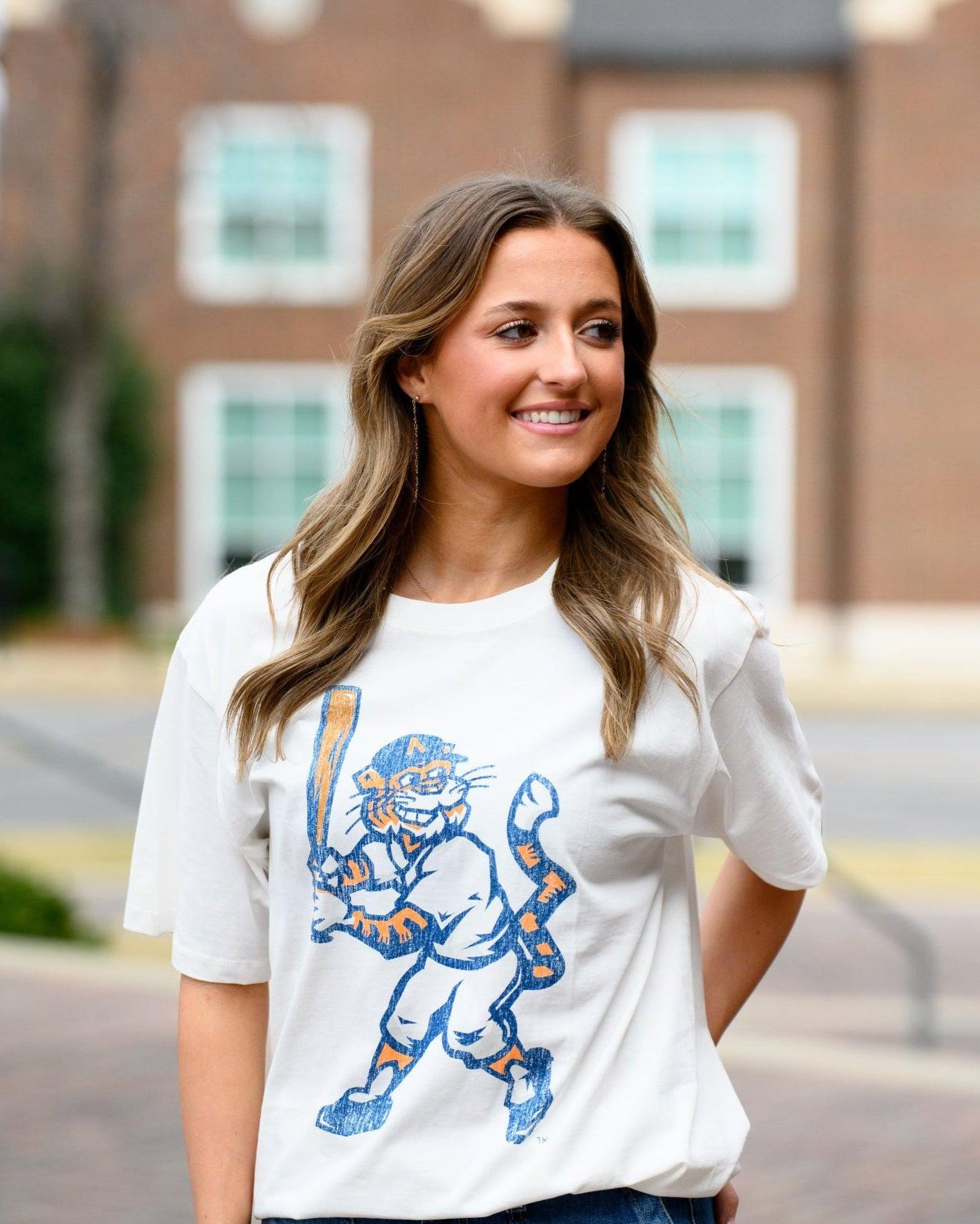Auburn University Aubie Vintage Baseball Ivory SoftShirts T-Shirt with an image of a vintage Aubie in a baseball uniform holding a baseball bat