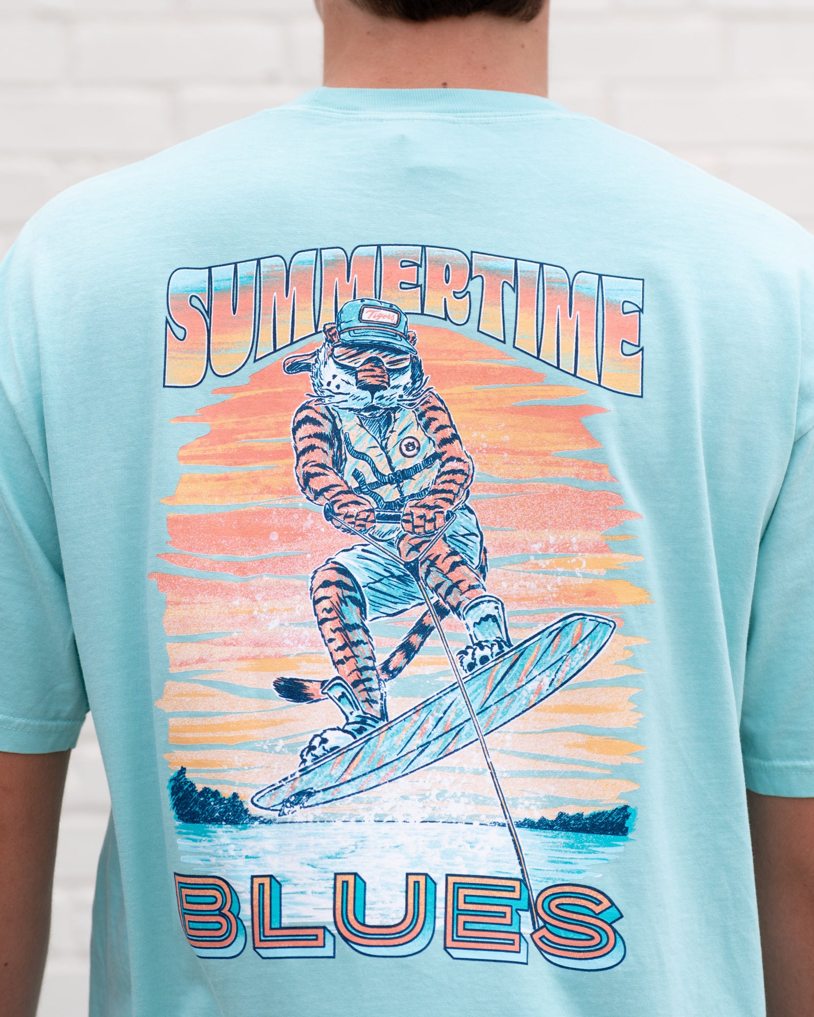 Auburn University Light Blue T-Shirt with an image of Aubie wakeboarding in between text “Summertime Blues”