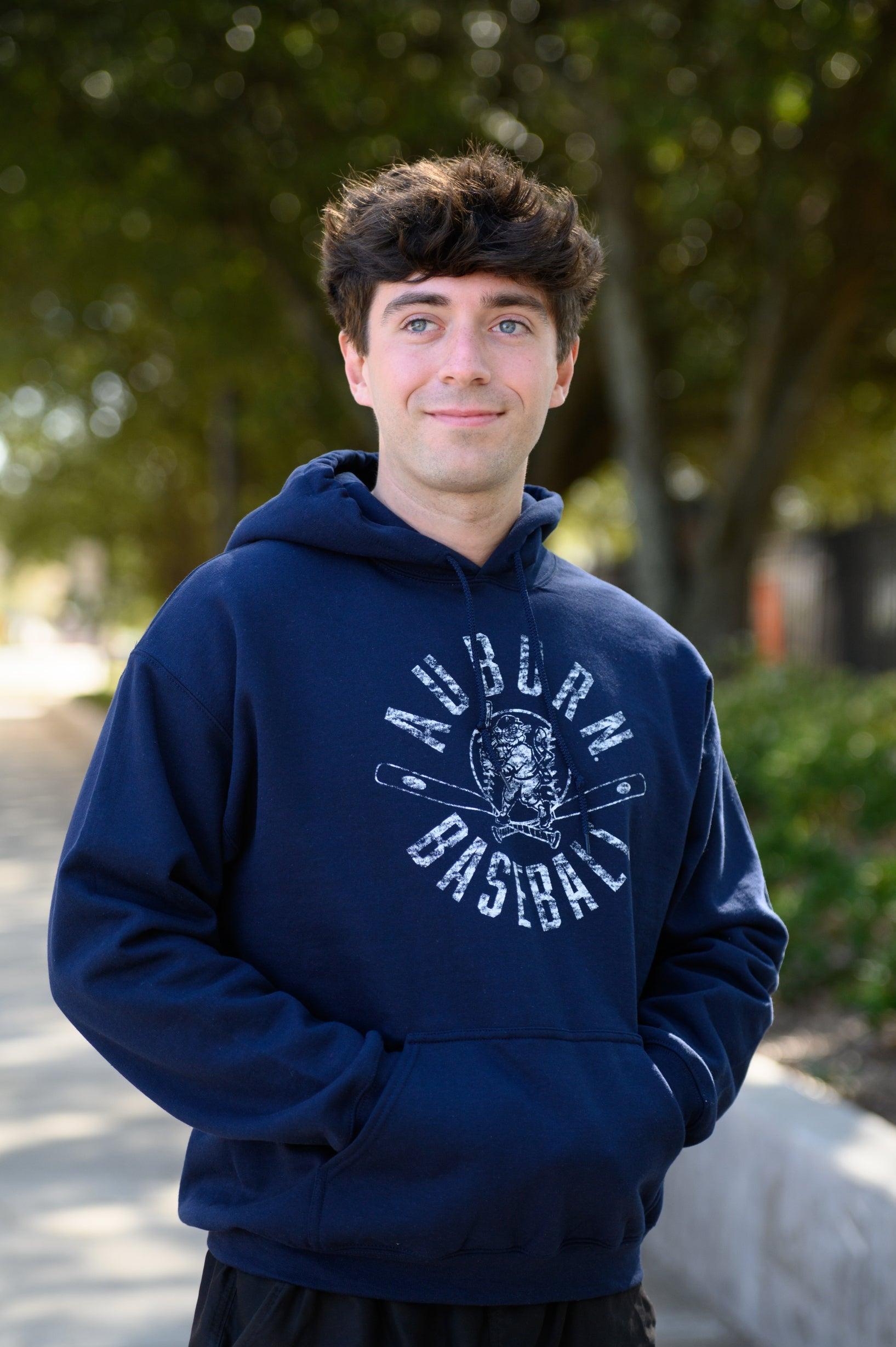 Auburn University Distressed Navy Hoodie with a White Baseball featuring the Original Aubie Baseball logo over crossed baseball bats, surrounded by White text “Auburn Baseball”