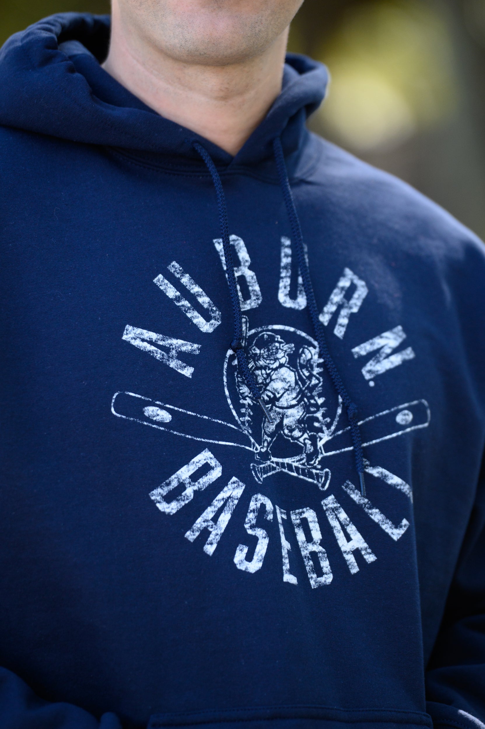 Auburn University Distressed Navy Hoodie with a White Baseball featuring the Original Aubie Baseball logo over crossed baseball bats, surrounded by White text “Auburn Baseball”