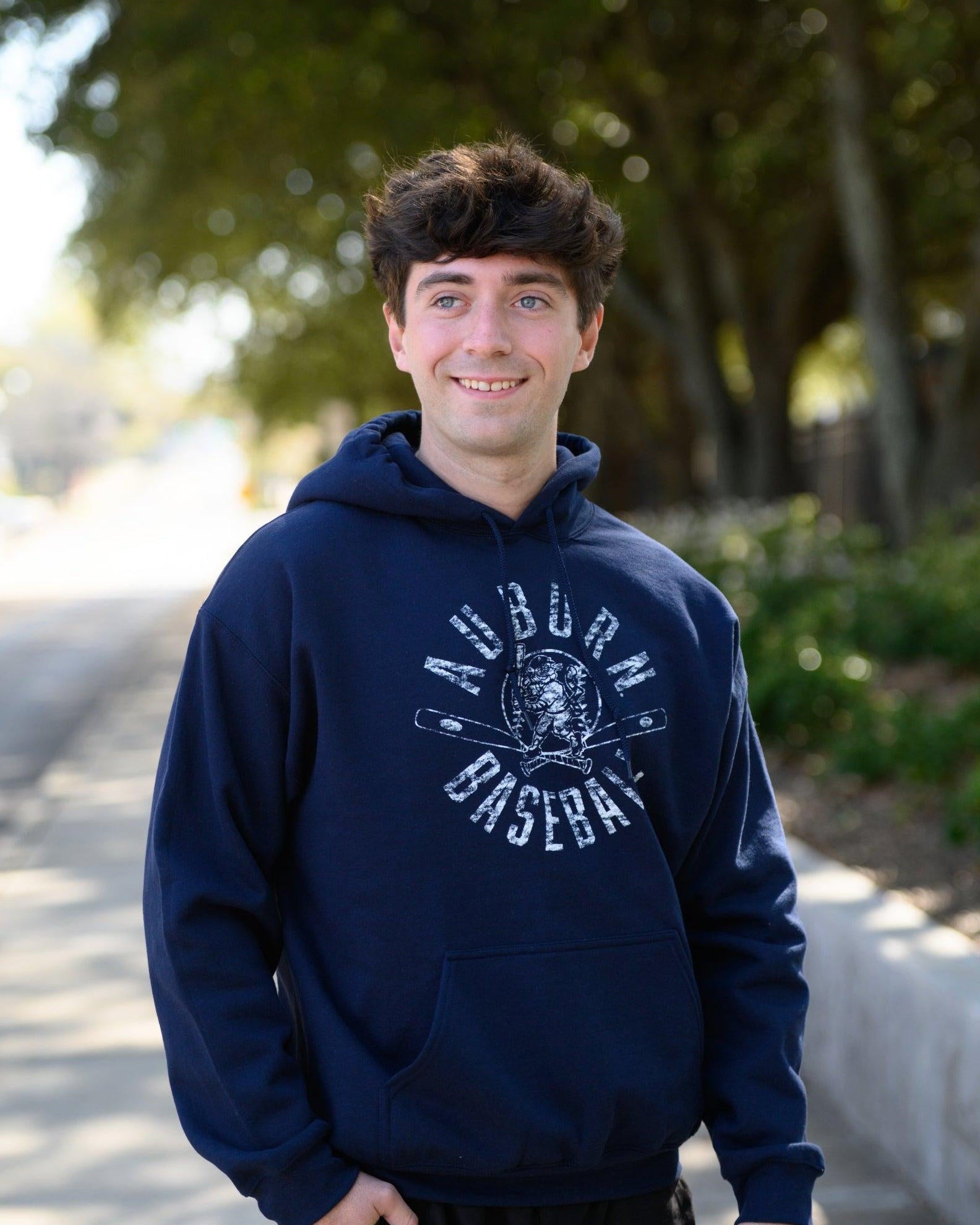 Auburn University Distressed Navy Hoodie with a White Baseball featuring the Original Aubie Baseball logo over crossed baseball bats, surrounded by White text “Auburn Baseball”
