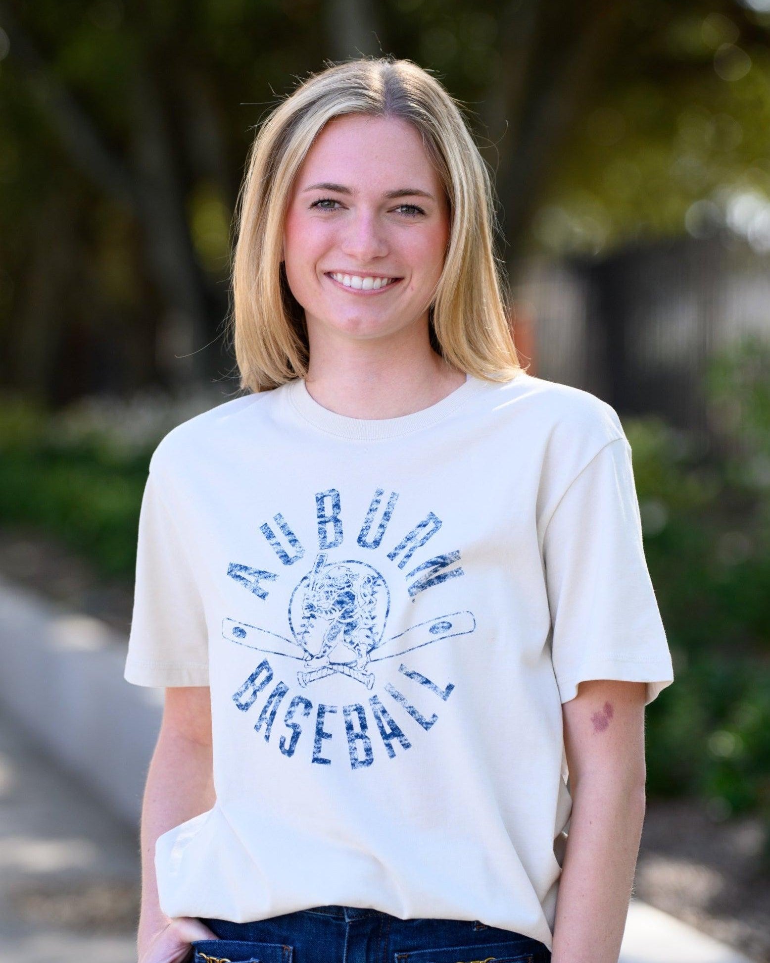Auburn University Distressed Ivory with a Blue Baseball featuring the Original Aubie Baseball logo over crossed baseball bats, surrounded by Blue text “Auburn Baseball”