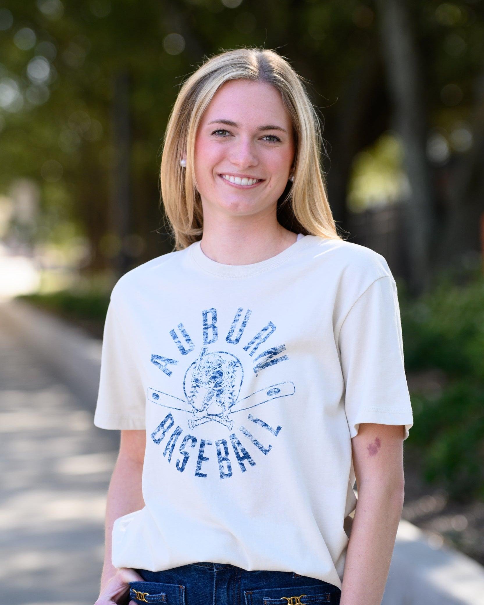 Auburn University Distressed Ivory with a Blue Baseball featuring the Original Aubie Baseball logo over crossed baseball bats, surrounded by Blue text “Auburn Baseball”