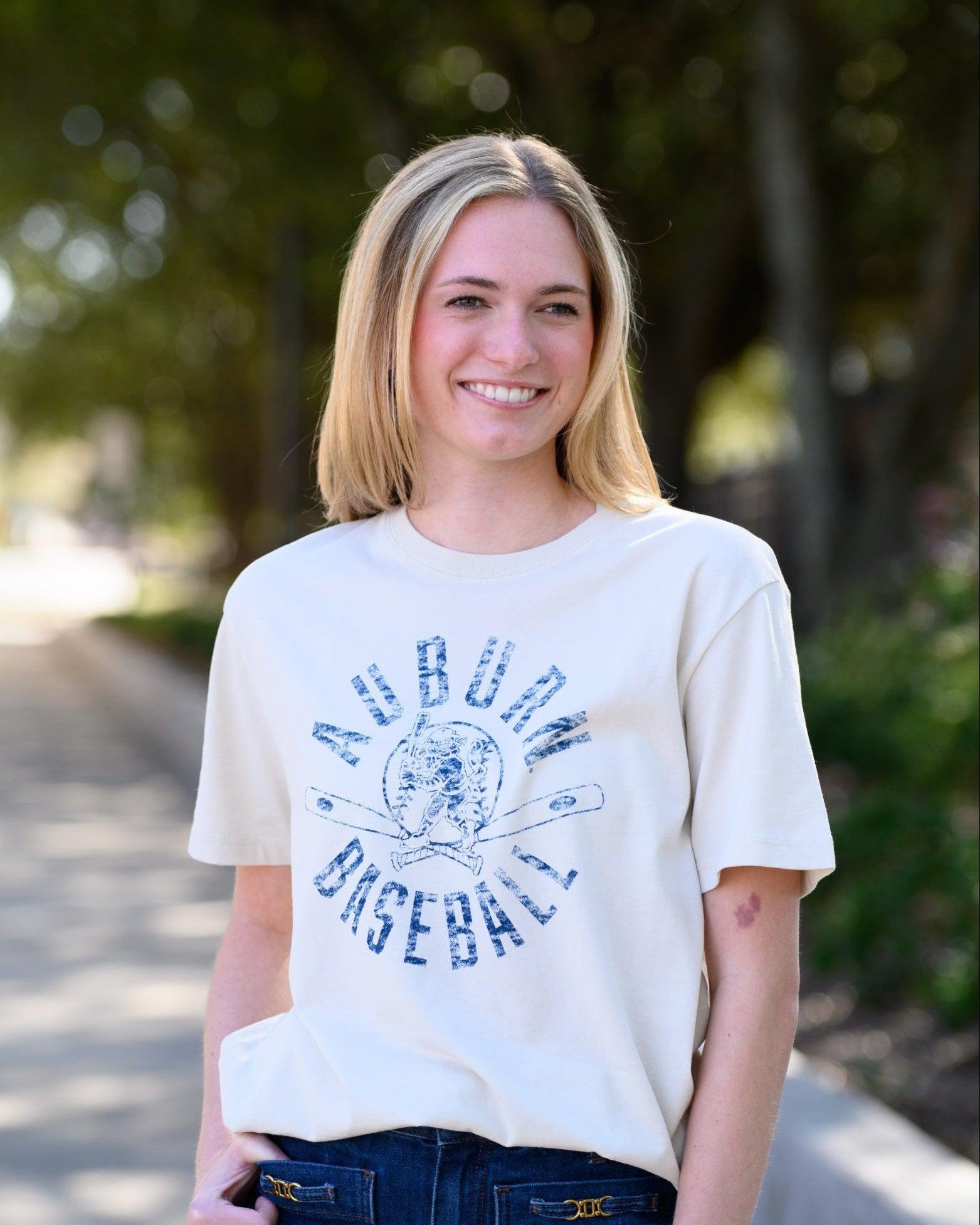 Auburn University Distressed Ivory with a Blue Baseball featuring the Original Aubie Baseball logo over crossed baseball bats, surrounded by Blue text “Auburn Baseball”