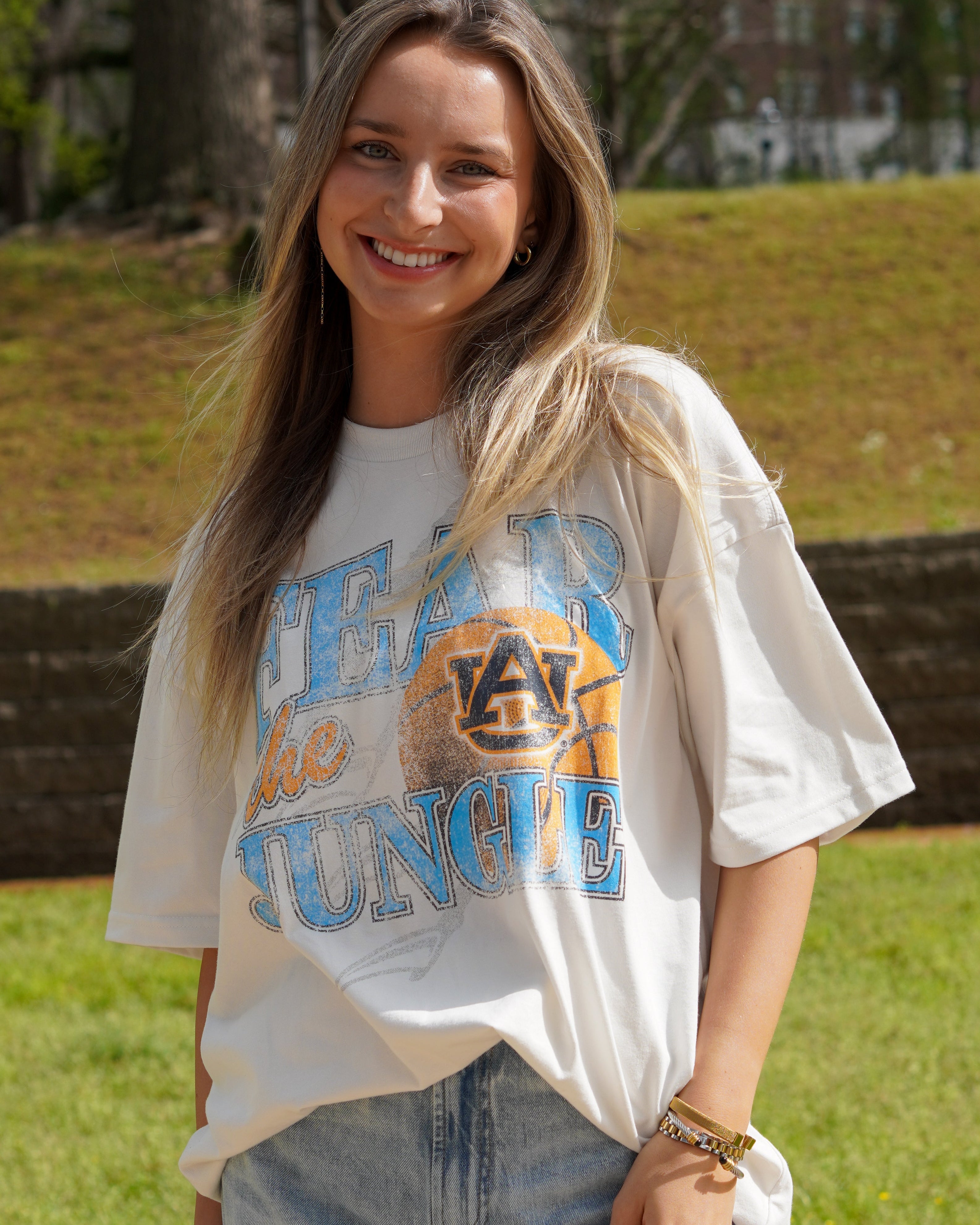 Auburn University Off-White T-Shirt with 'FEAR THE JUNGLE' text, a basketball with the AU Logo and tiger claw marks design