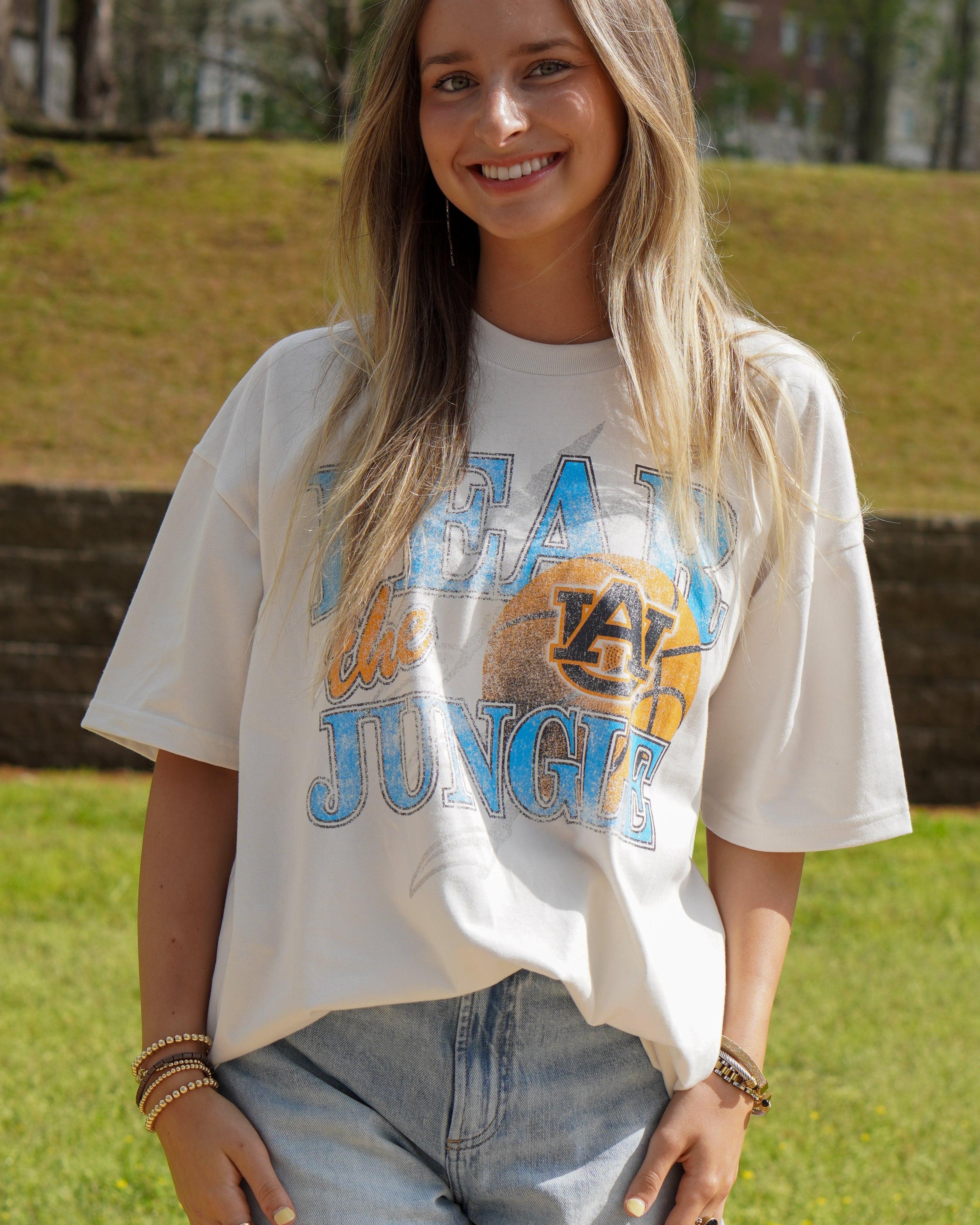 Auburn University Off-White T-Shirt with 'FEAR THE JUNGLE' text, a basketball with the AU Logo and tiger claw marks design