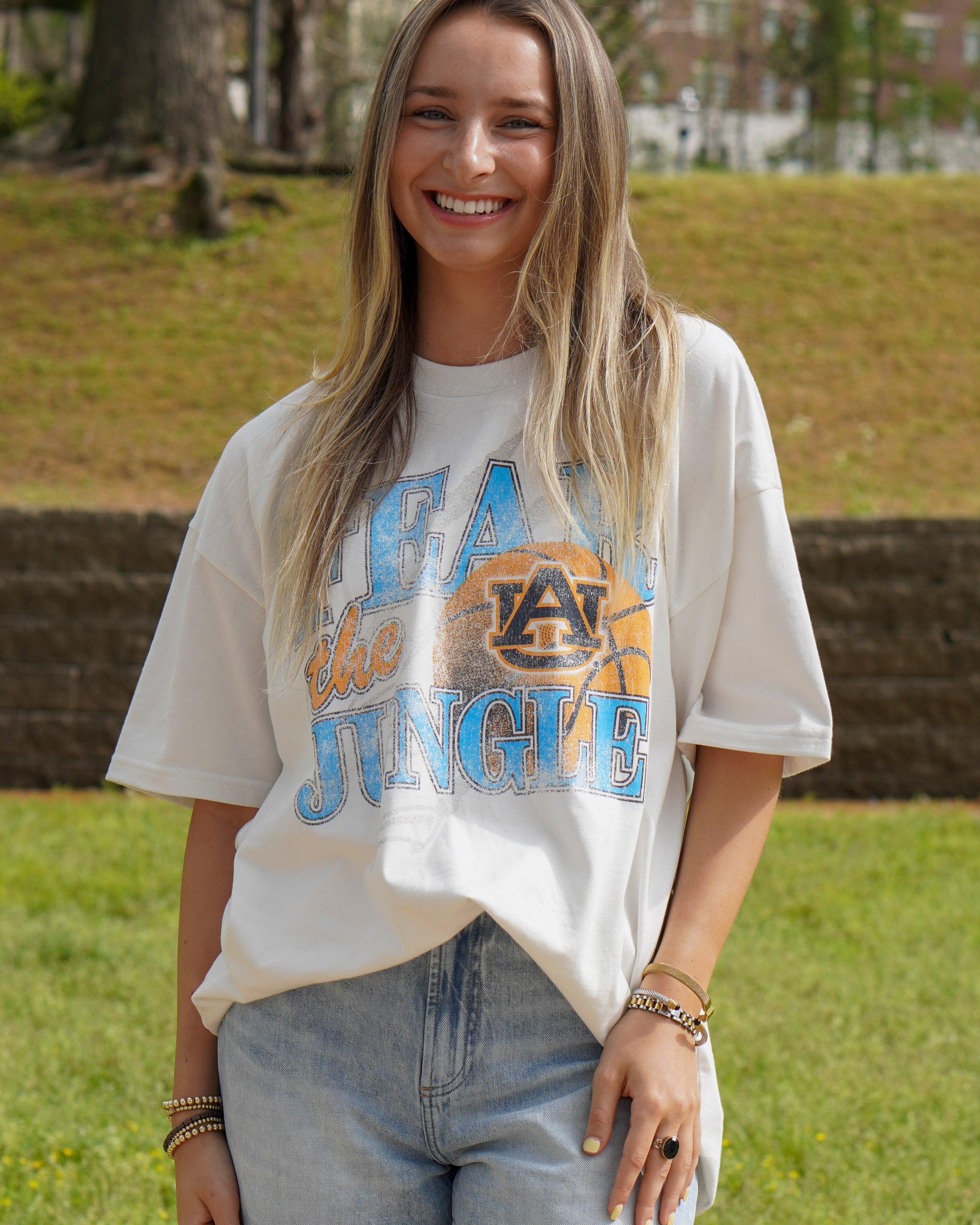 Auburn University Off-White T-Shirt with 'FEAR THE JUNGLE' text, a basketball with the AU Logo and tiger claw marks design