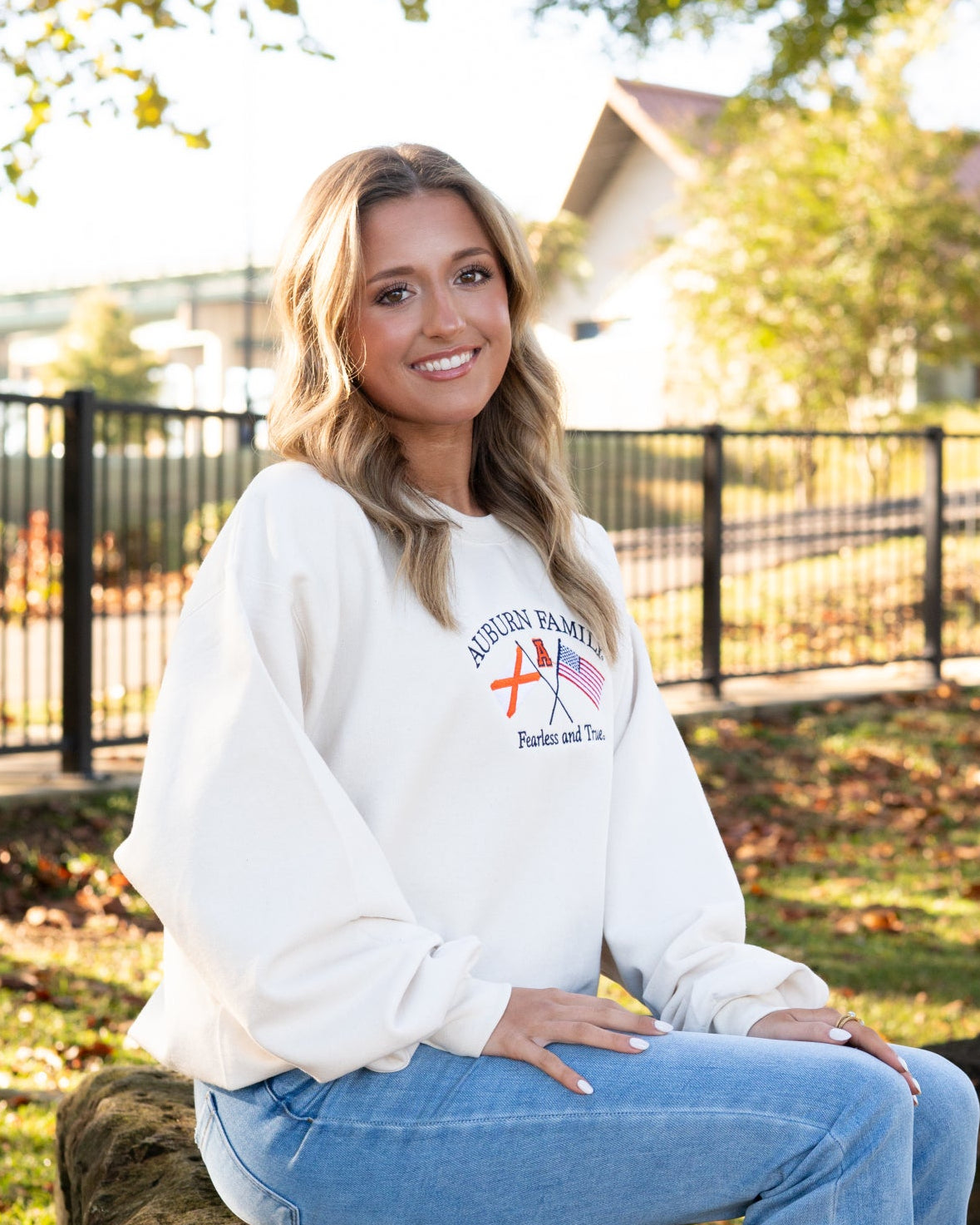Auburn University Cream Sweatshirt with Navy text “Auburn Family” above the state flag and American flag crossed under the Block Auburn A