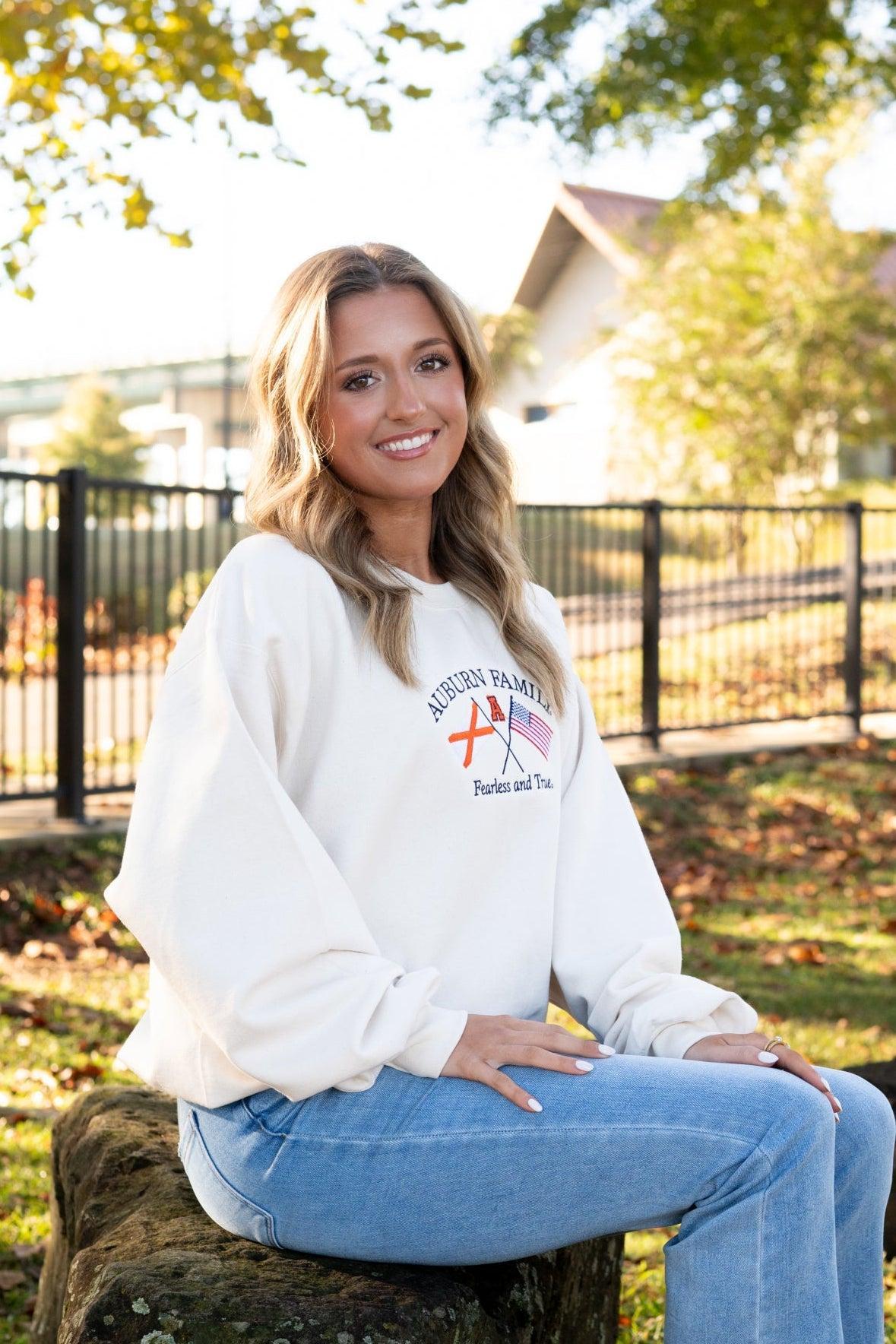 Auburn University Cream Sweatshirt with Navy text “Auburn Family” above the state flag and American flag crossed under the Block Auburn A